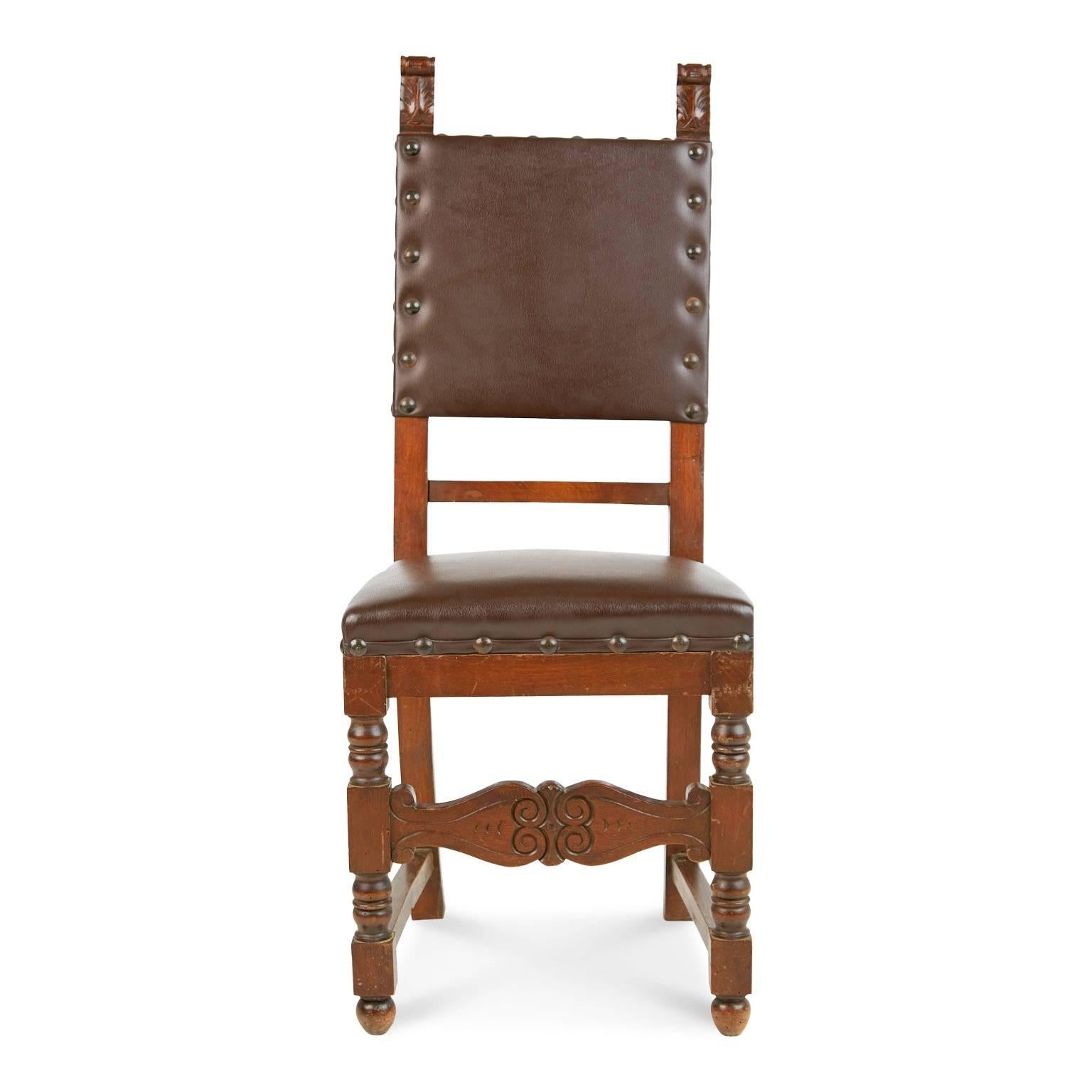 Beautifully crafted pair of aged Italian Renaissance Revival style side chairs. Each feature foliate finials, turned legs and carved stretchers across the front with coiled embellishments. The upholstery on the seats and backs is a rich brown