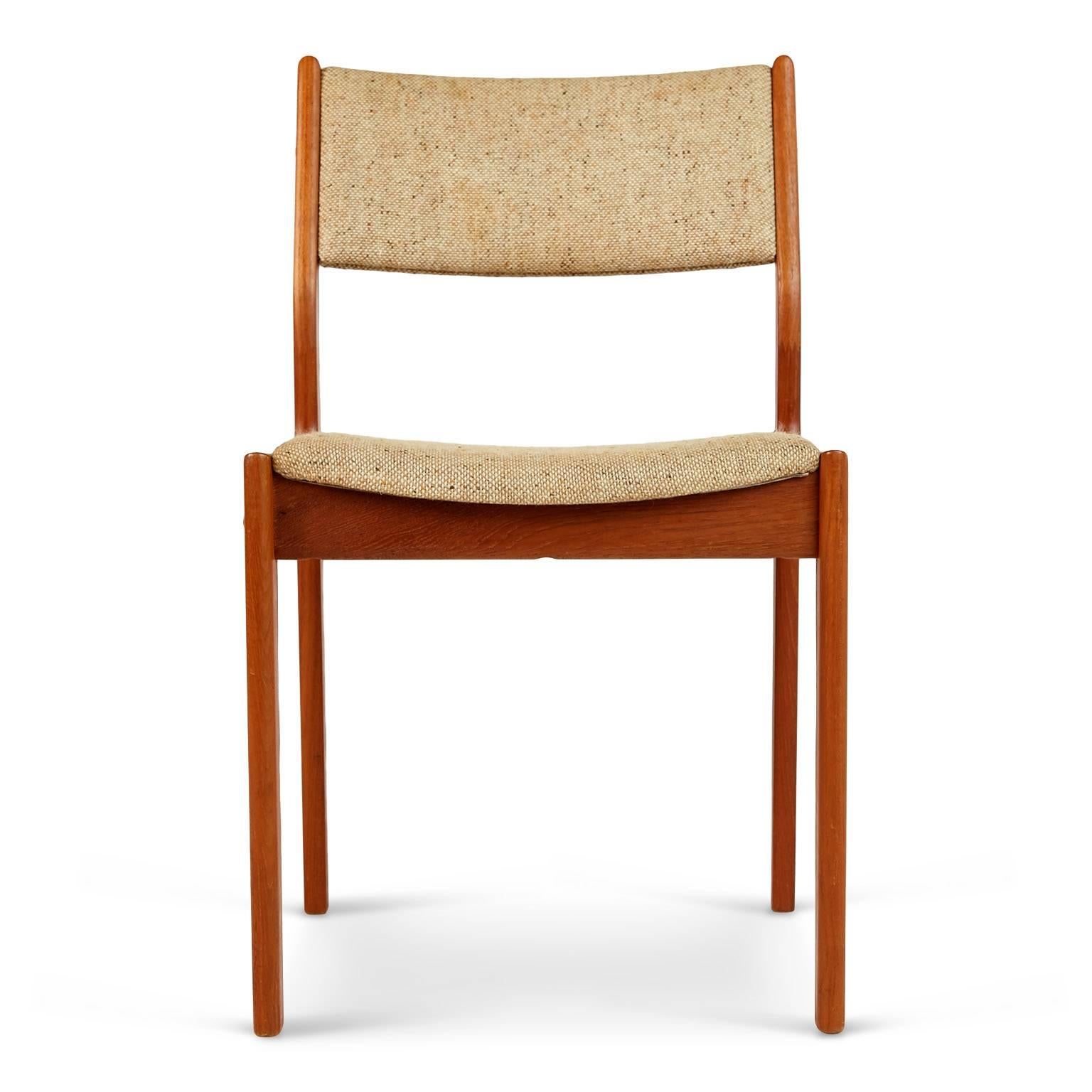 Set of four Danish Modern chairs comprised of warm wood grained teak upholstered in the original woven fabric which is a blend of cream, sand, taupe and ochre. 

This versatile set would be great used together or individually around the house in a