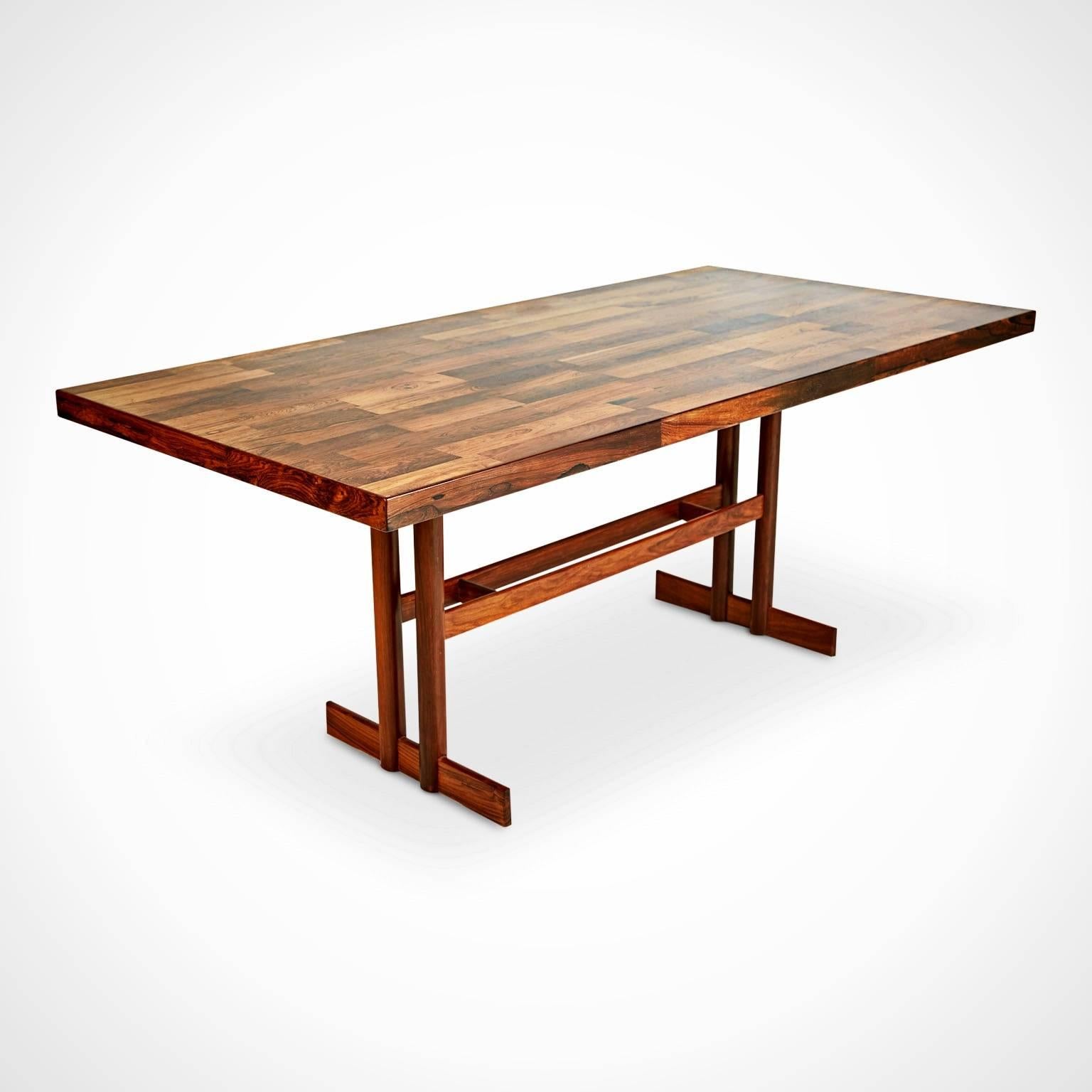 Expertly crafted Brazilian parquetry trestle table, possibly from Jorge Zalszupin, which has been recently restored. This striking dining table, which could also be used as a conference table or floating desk, is fabricated from solid rosewood with
