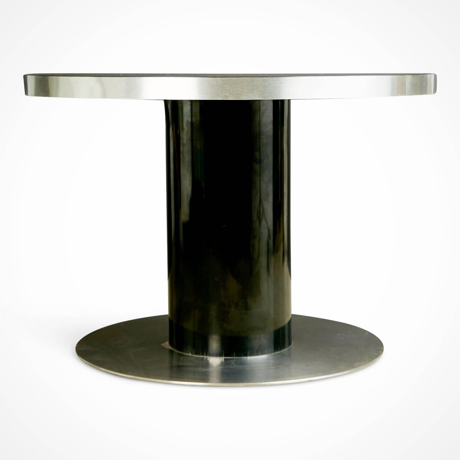 Elegant dinette table comprised of laminate and steel by Italian designer Willy Rizzo. The modern pedestal design consists of a solid laminate top and base consisting of a laminated column and steel foundation. Rizzo was known for deliberately