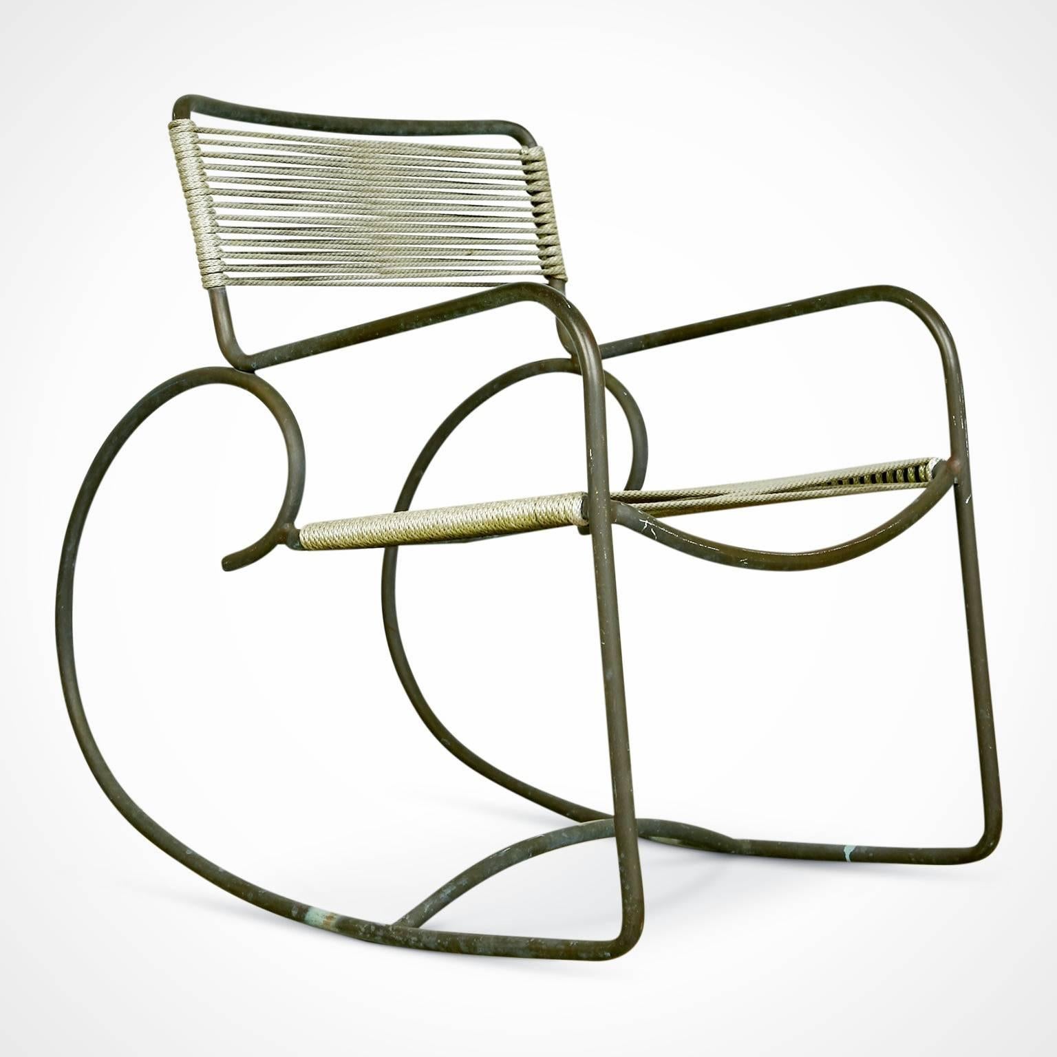 Bronze rocking chair designed by Walter Lamb and manufactured by Brown Jordan. A rarity with the original label still in-tact as these, being usually used outdoors, tend to lose the labels on the lower cross-bar. This, plus its excellent original