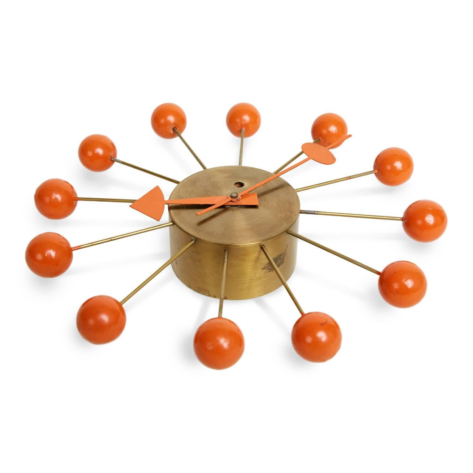 Classic vintage ball clock designed by George Nelson and Irving Harper for Howard Miller. The Ball Clock, first produced in 1949, is a fun and eye-catching wall adornment which will add a bit of interest to any space. Featuring a brushed brass base