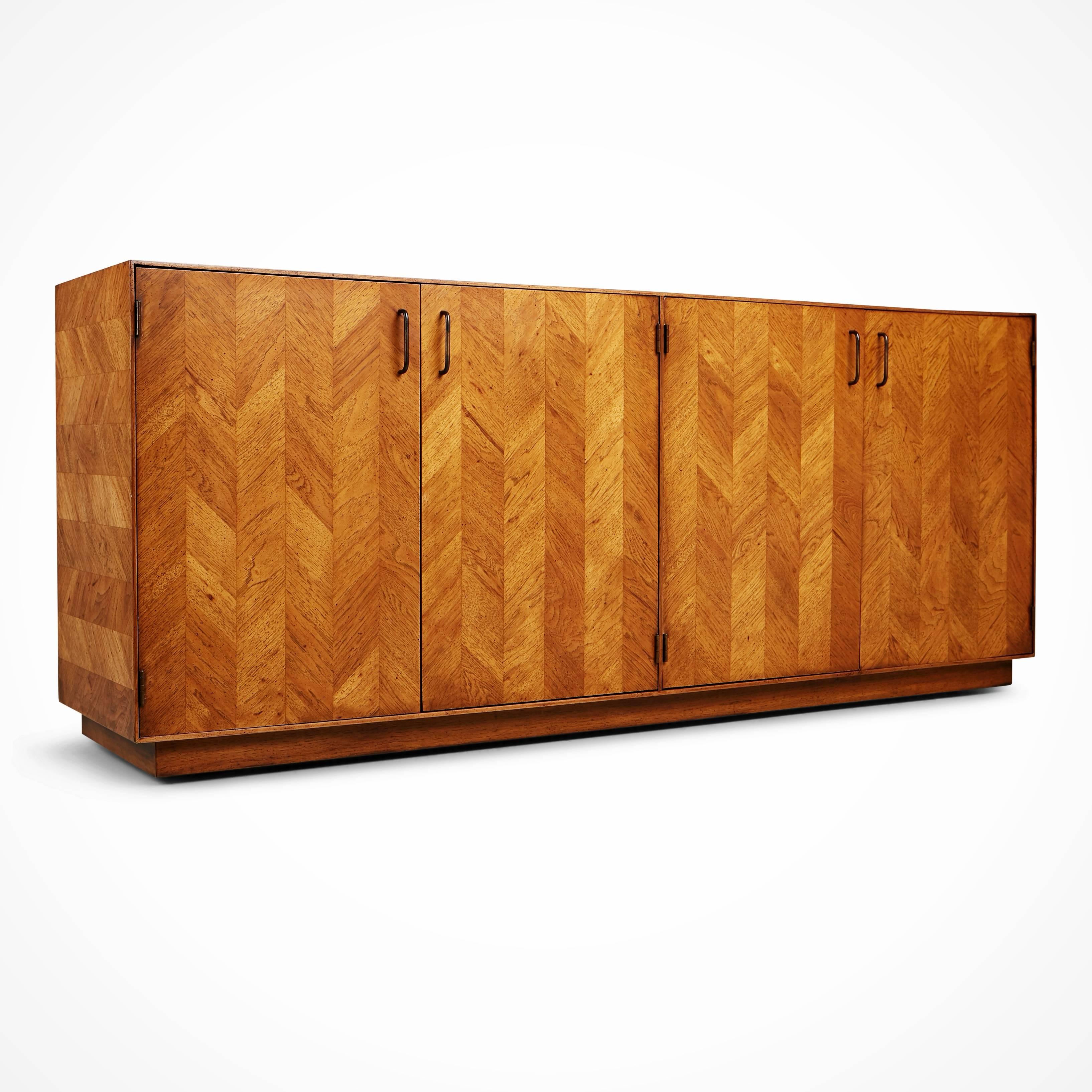 Newly restored expansive sideboard (or credenza) by Lane. Featuring an attractive parquet frontage on the cabinets which has been newly refinished, bringing out the intricacies of the beautiful herringbone pattern. The left hand cupboard opens to
