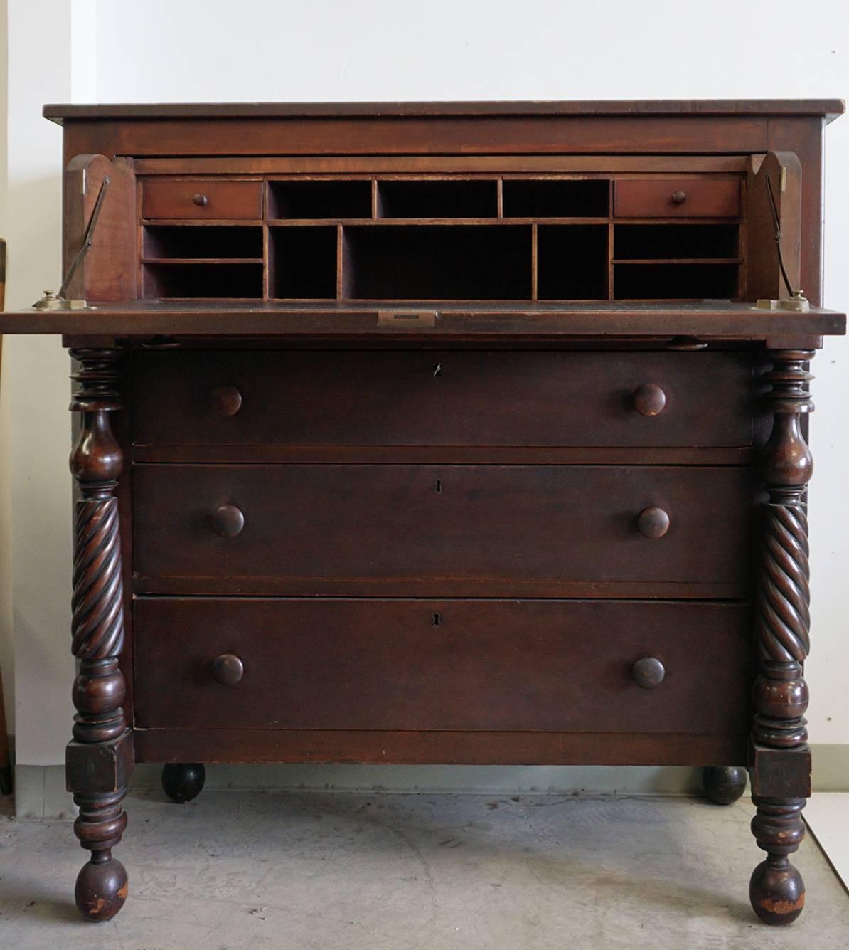 Cherry drop front butler chest with desk drawer.