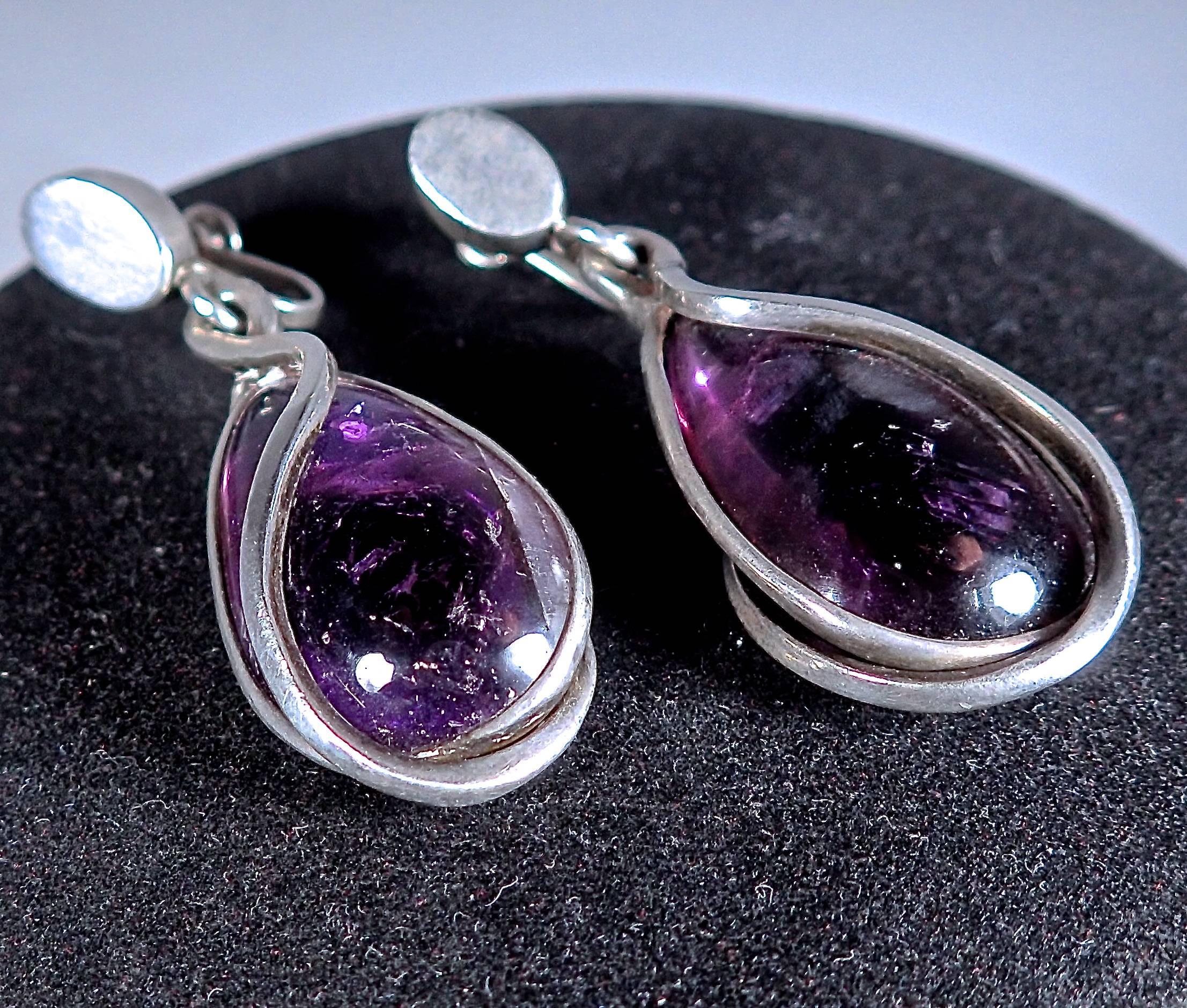 Two teardrop amethyst stones-with stunning color-are set with cascading silver wire detail creating the drop earring. Screw-post can be altered to a post backing (for pierced ears), or clip on; maintaining the integrity of Pineda's hallmarks. Signed
