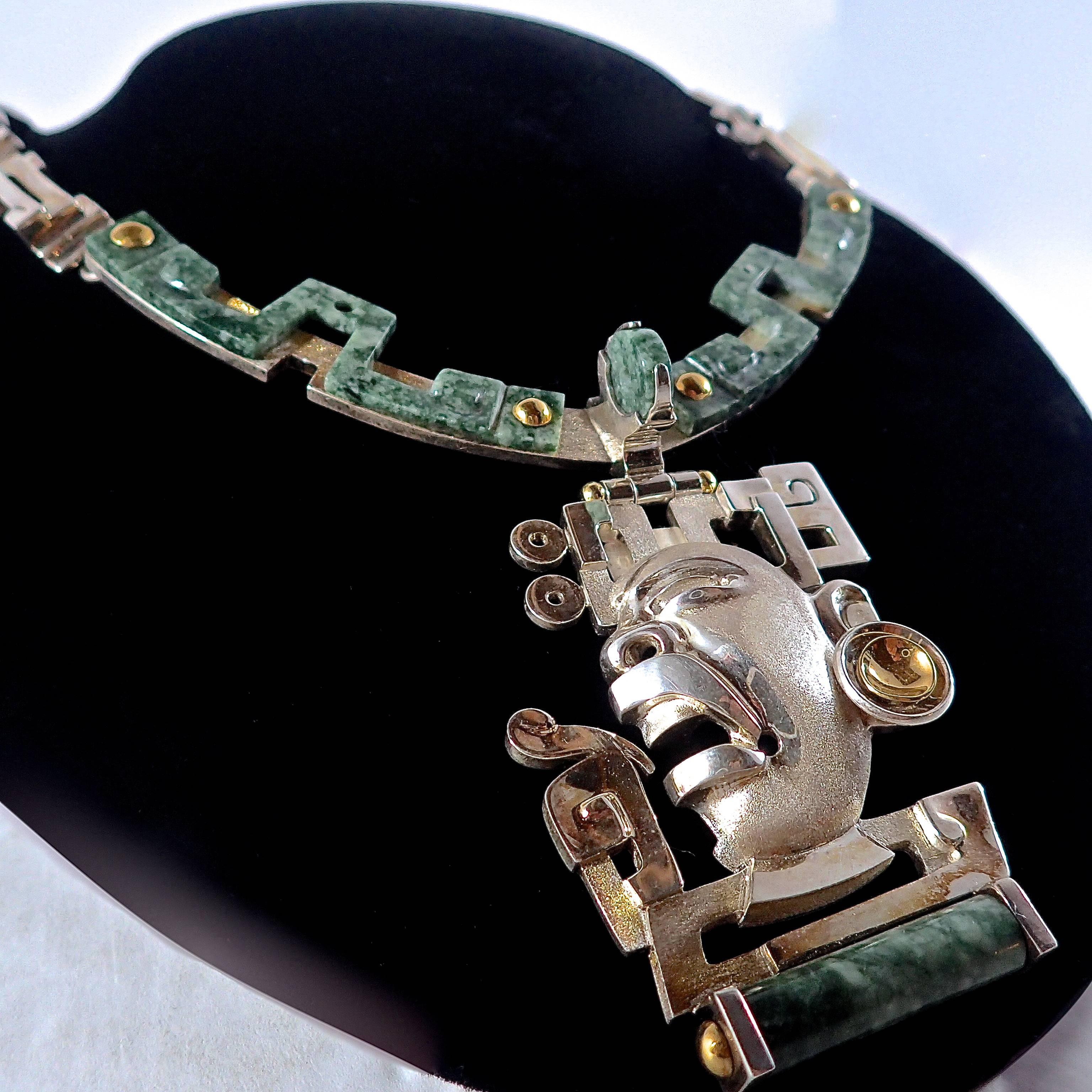 Olmec face inspired pendant-necklace featured with hand-cut Jade and accented with 22K gold. Completed with a hand crafted tension box clasp.

Creating his works completely by hand, these are one-of-a-kind pieces. Implementing various techniques