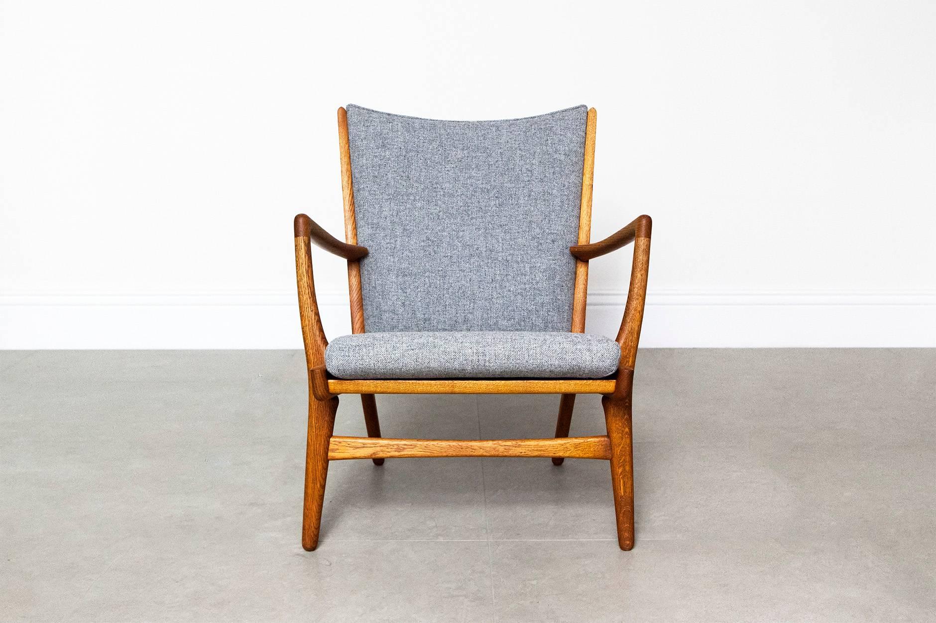 Oak armchair from Danish master Hans Wegner, designed for cabinet maker AP Stolen in 1952. This model was part of the same series as Wegner's iconic Papa Bear chair and was made in small quantities. The seat and back have been reupholstered in