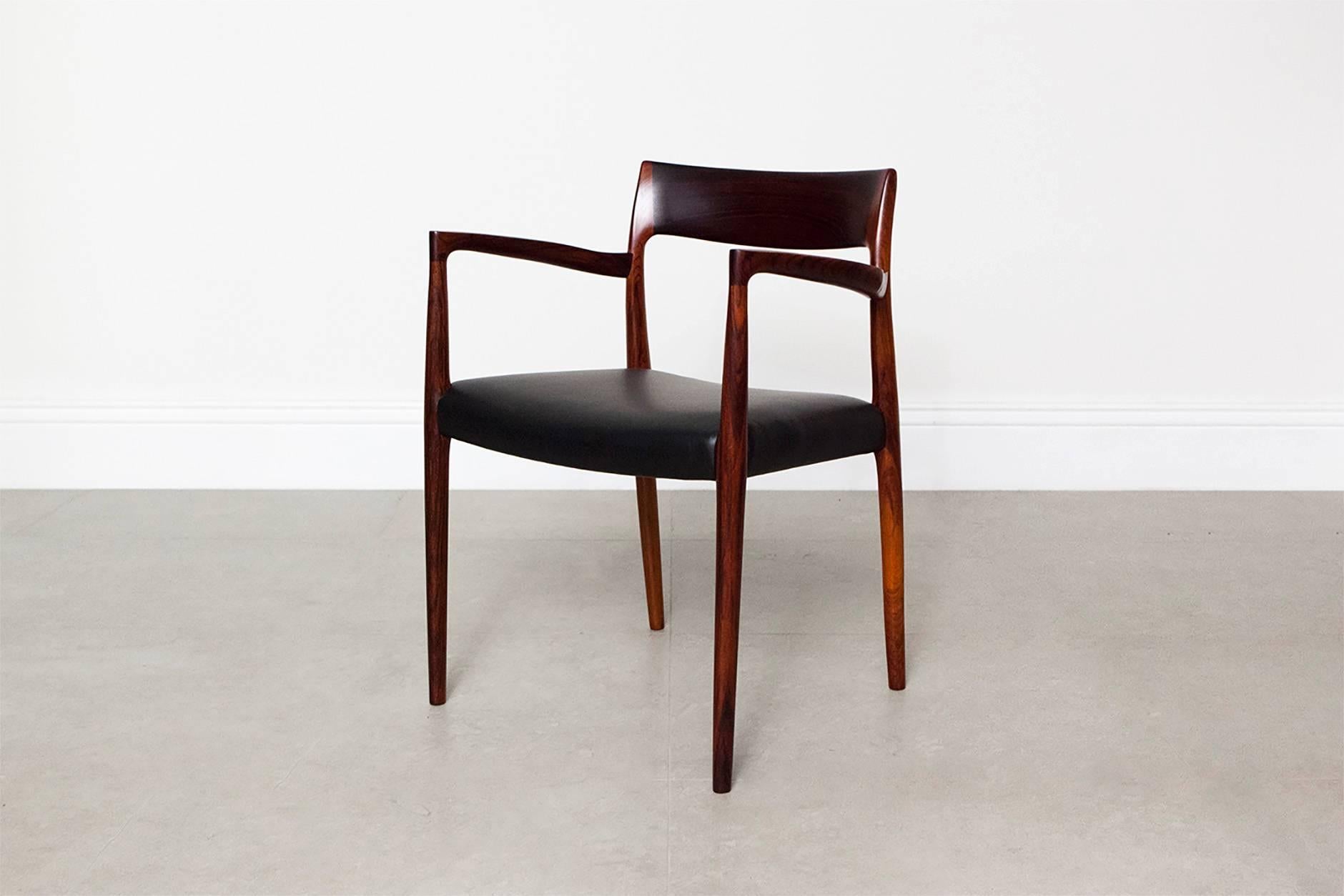 Model 57 chair from Danish designer Niels Moller for J.L Moller Mobelfabrik, 1959. The seat has been reupholstered with new black leather. 