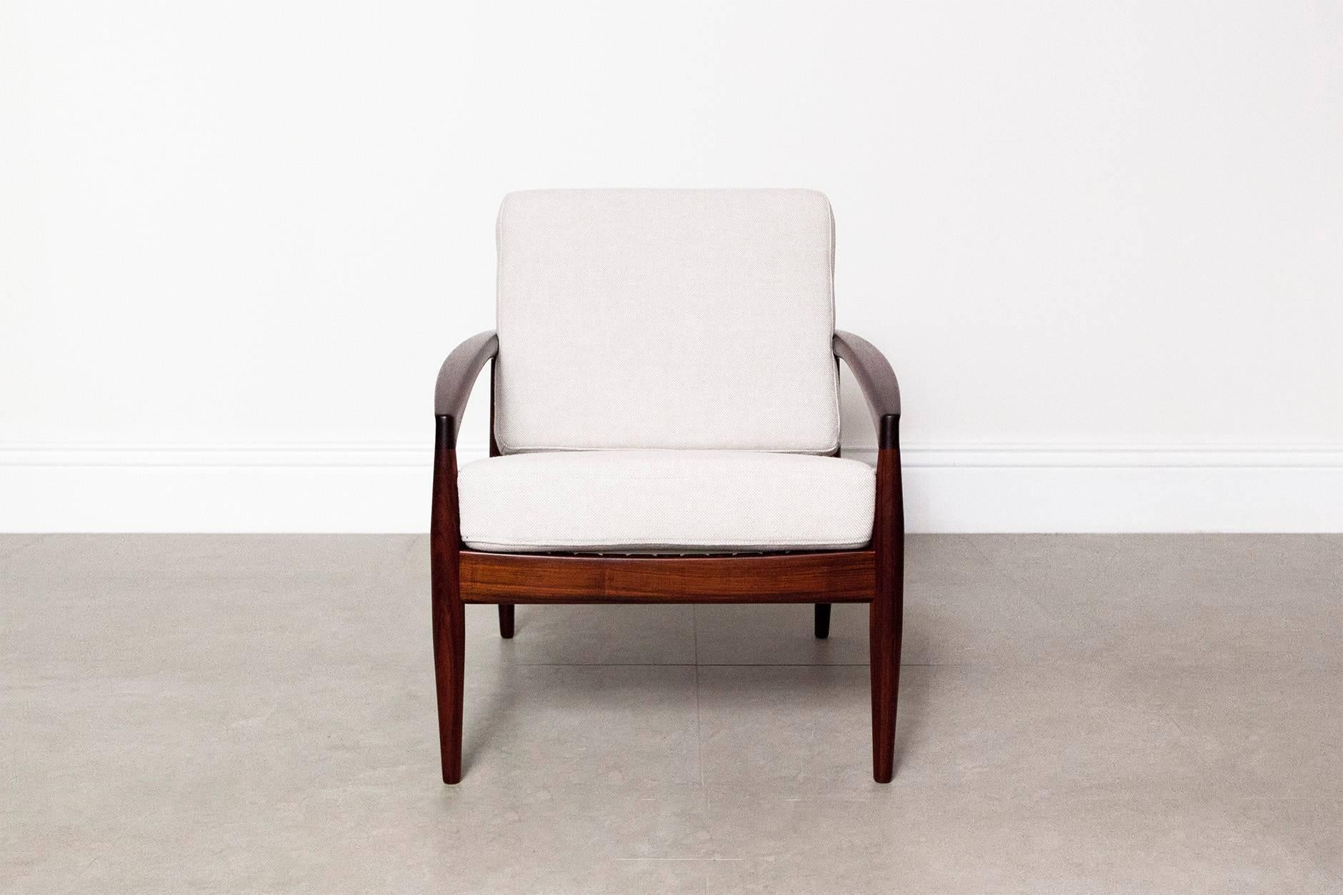 The iconic 'Paper Knife' model 121 chair from Danish designer Kai Kristiansen in solid rosewood, manufactured by Magnus Olesen, circa 1955. The new cushions have been reupholstered in a light grey Hallingdal fabric by Kvadrat. 