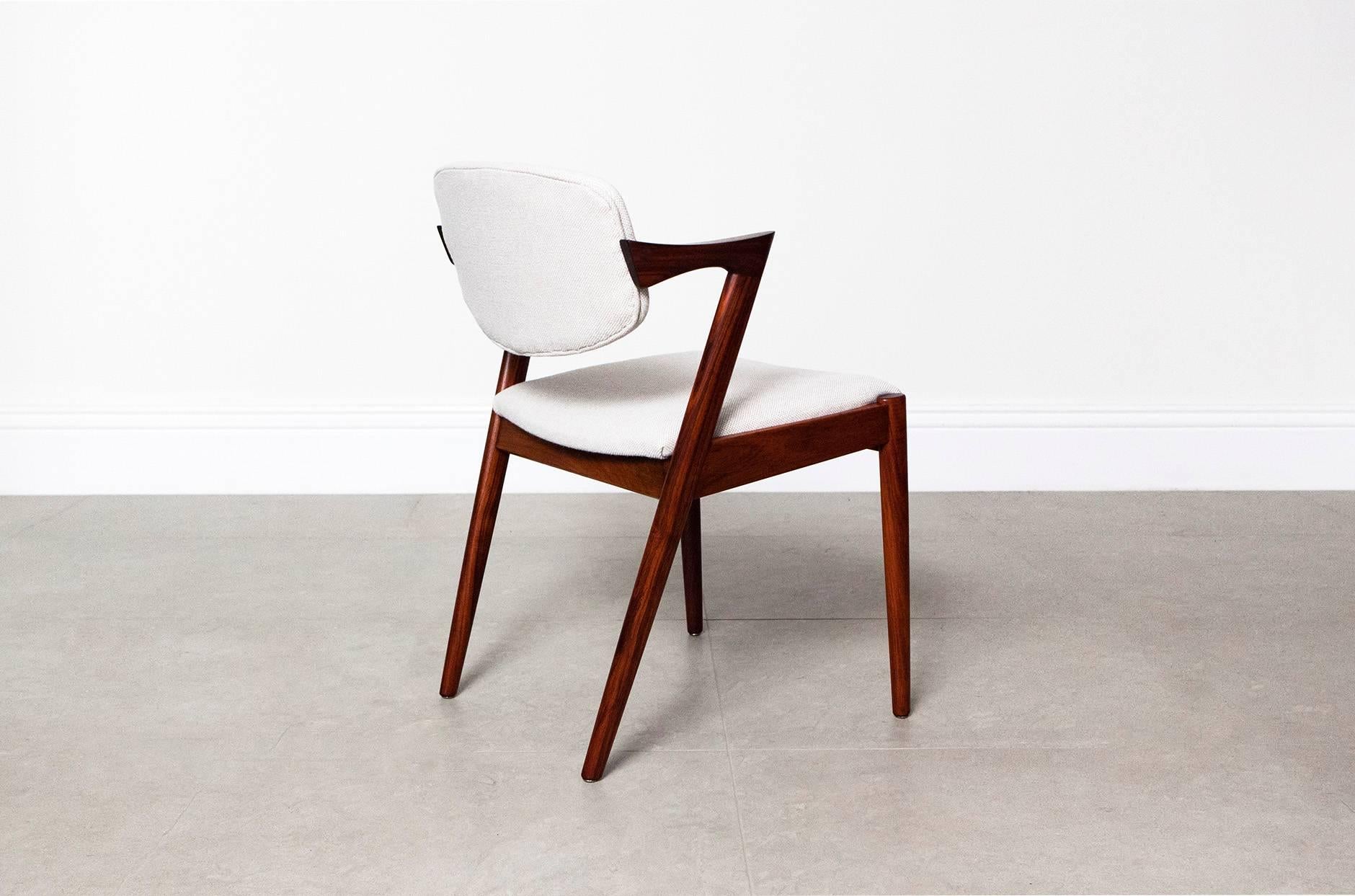 The iconic model 42 chair from Kai Kristiansen, also know as the 'Z' chair. This set comes in rare Brazilian rosewood with a wonderfully exotic grain. The back supports pivot making them incredibly comfortable. Seat and back pads have been recovered
