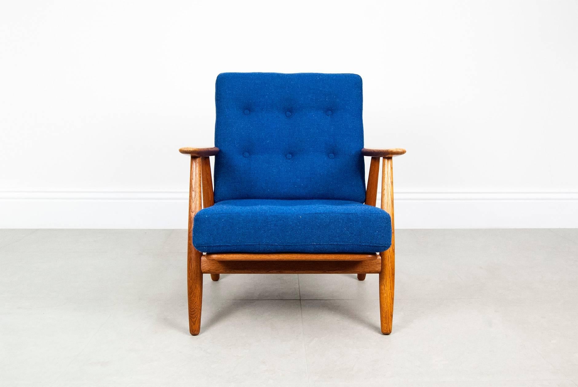 Hans J. Wegner GE-240 cigar chair, circa 1955. Produced by GETAMA, Denmark. Solid oak frame, original sprung cushions reupholstered in blue Bute tweed wool fabric.