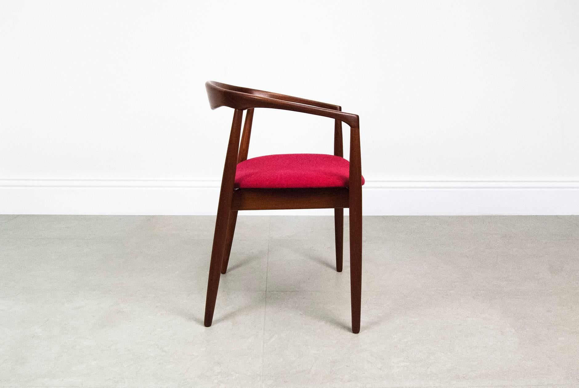 Kai Kristiansen 'Troja' round chair, circa 1960. Afromosia teak round armchair. Seat pad reupholstered in cranberry-red Bute tweed wool fabric.