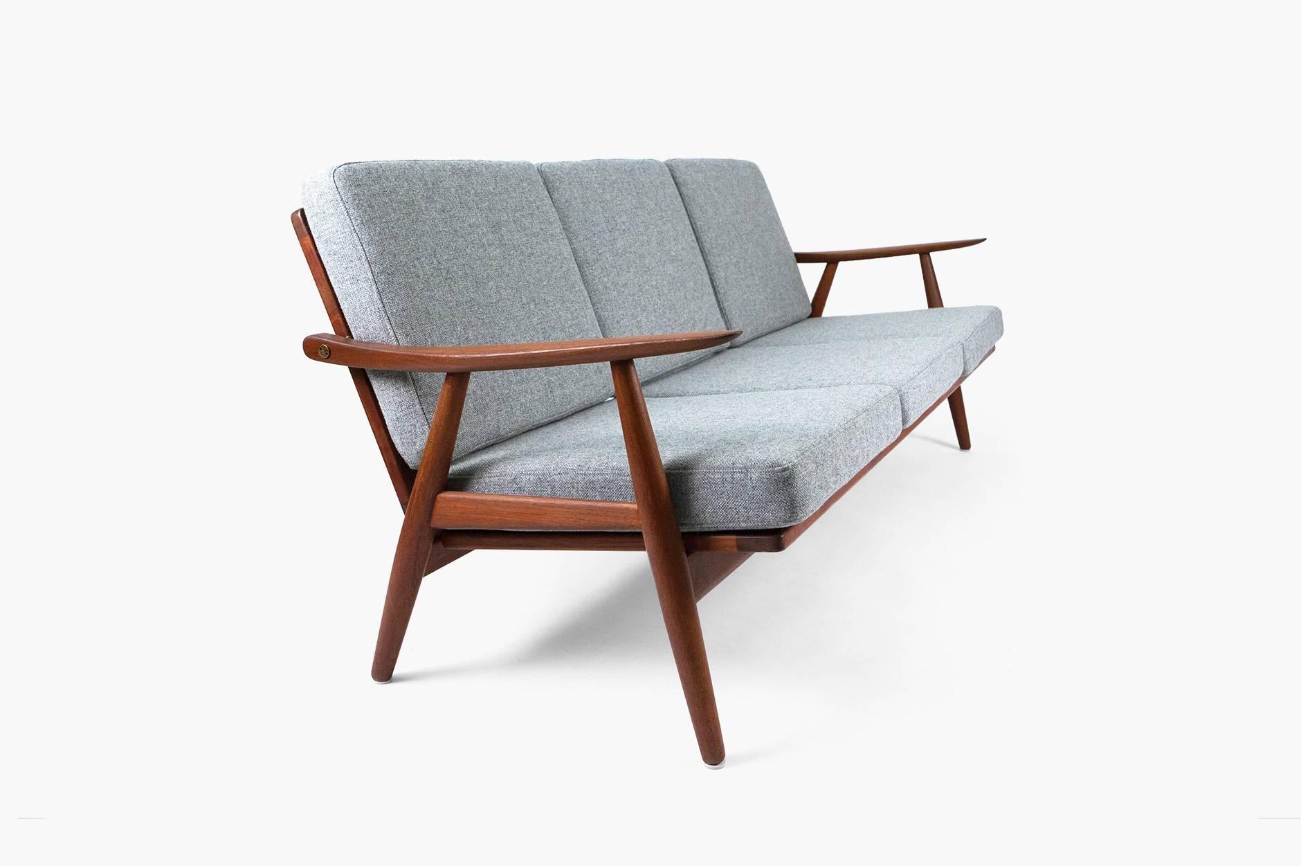 Rarely seen teak sofa produced by GETAMA, Gedsted, Denmark, circa 1954. Featuring bespoke exposed brass fittings. New cushions covered in Kvadrat Hallingdal 130.