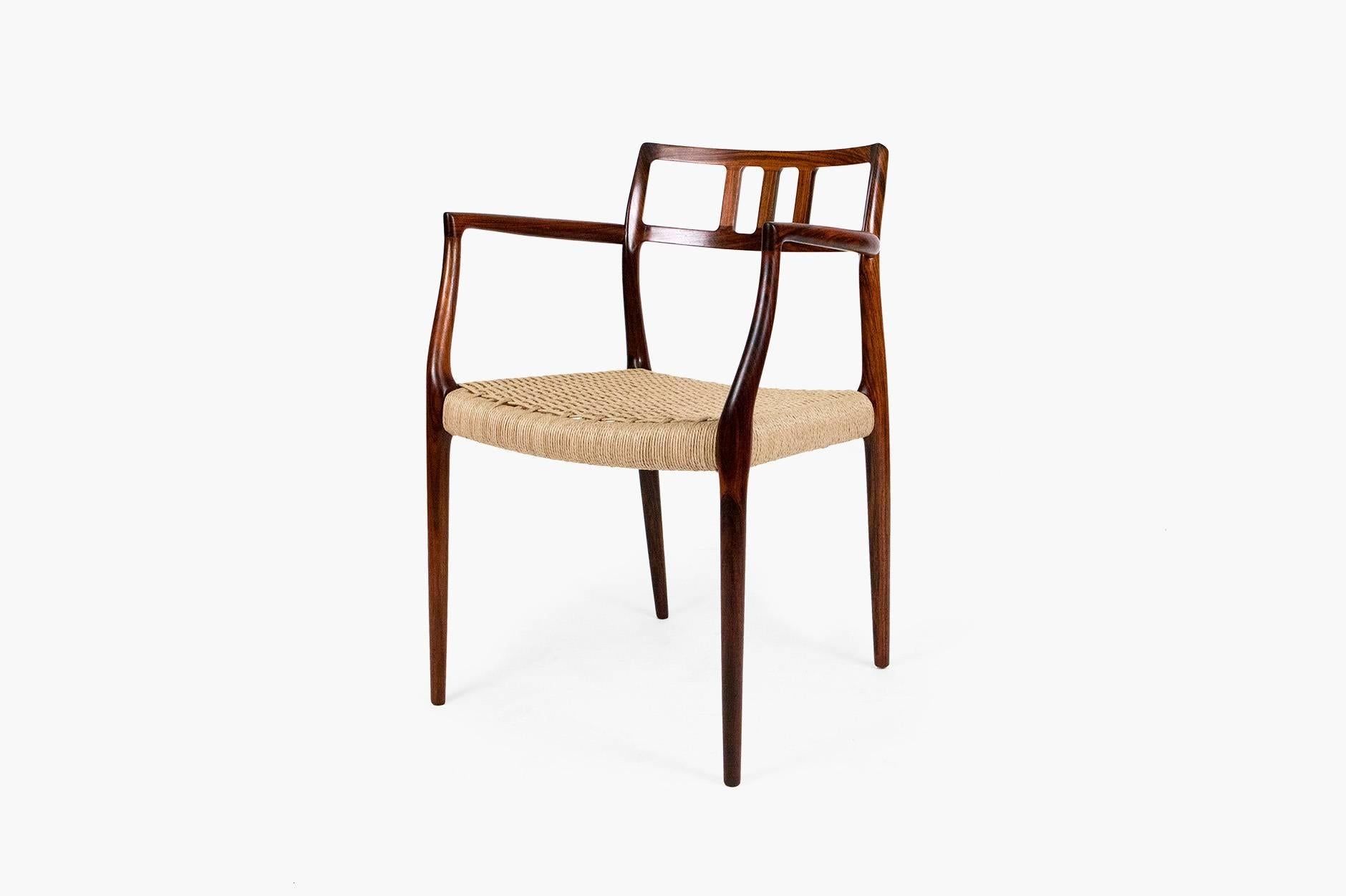 Solid Brazilian rosewood armchair designed by Niels Moller for JL Moller Mobelfabrik, Denmark, 1966. Model No. 64. Woven Danish papercord seat. Rarely seen and highly sought after model.
   