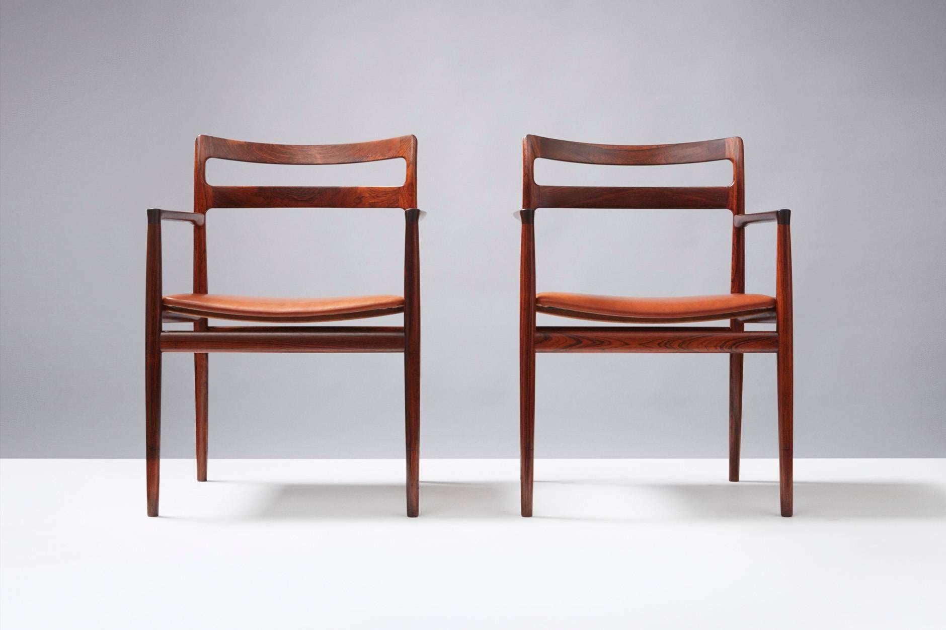 Rosewood armchairs attributed to Johannes Norgaard and produced by Norgaard Mobelfabrik, Denmark. New, aniline cognac brown leather seats.
  