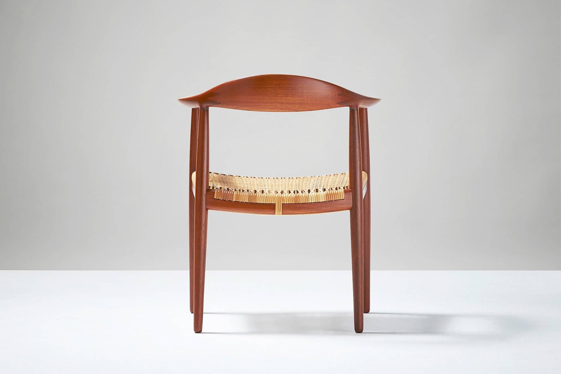 Teak frame with woven rattan seat and back. Rare early model of this iconic Wegner design. Produced by Johannes Hansen, Denmark. Minor breaks in rattan weave.