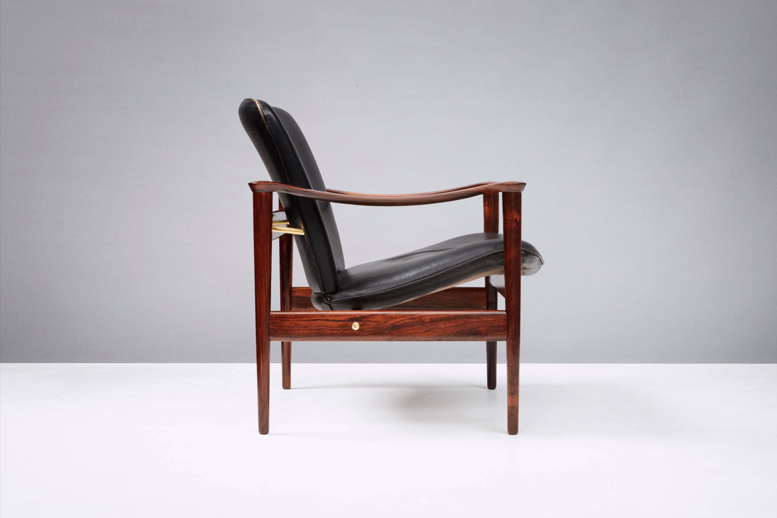 Fredrik Kayser Model 711 lounge chair, circa 1958, produced by Vatne Mobler, Norway. Brazilian rosewood frame, brass fittings and original patinated leather seat. 

