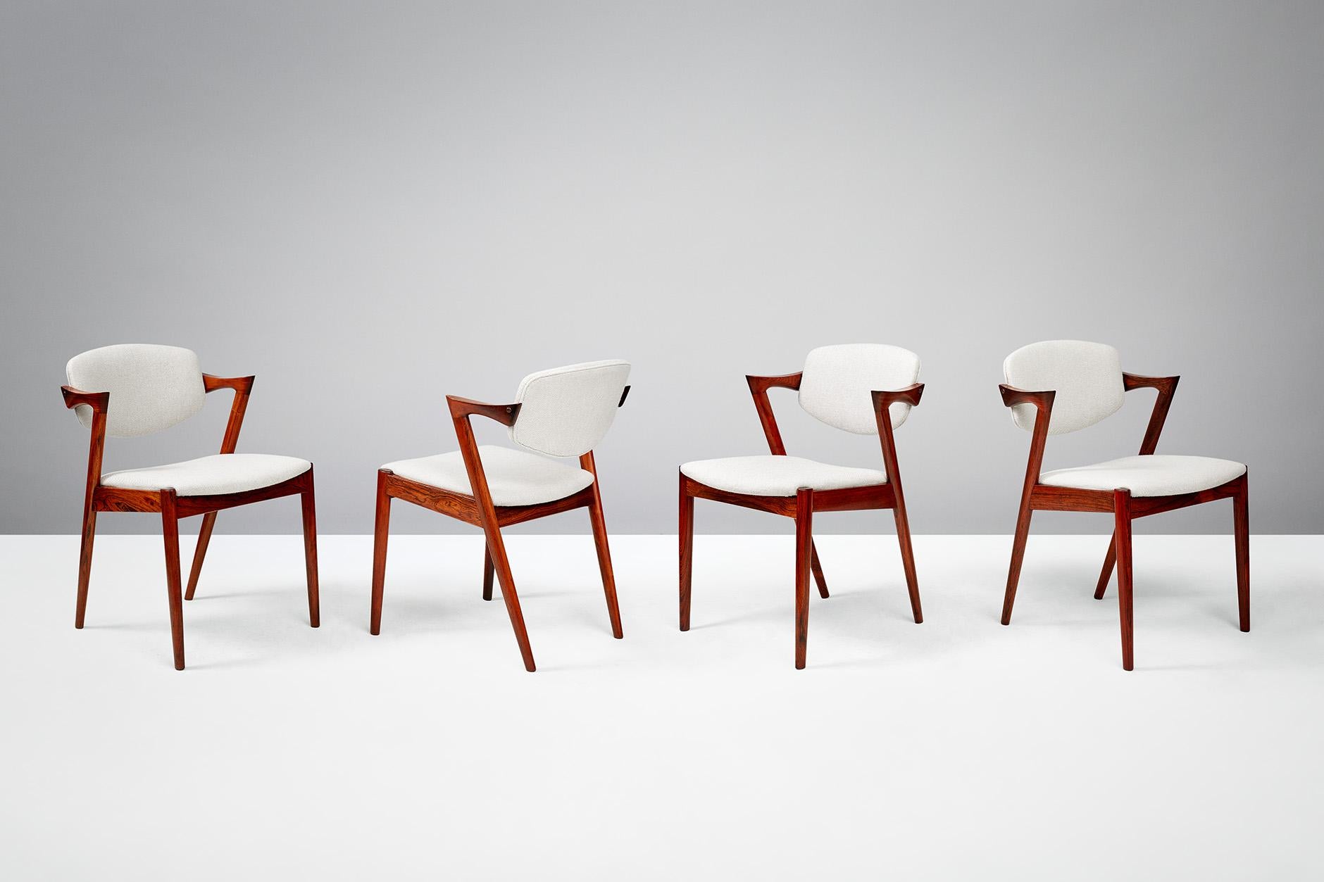 Kai Kristiansen
Model 42 dining chairs, 1956.

Set of 8 dining chairs produced by Skovman Andersen for the Illum Bolighus department store in Copenhagen. Refinished rosewood frames with seat and back reupholstered with Kvadrat Hallingdal wool