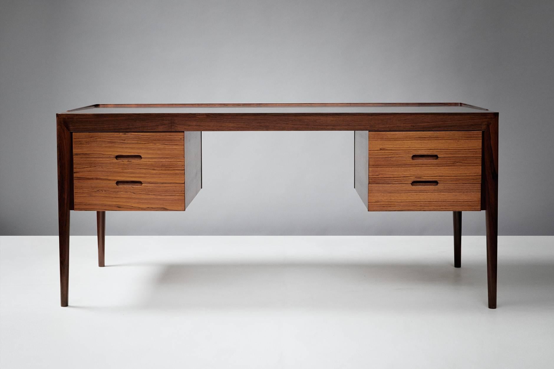 Produced by Haslev Mobelsnedkeri, Denmark. Solid rosewood legs and mouldings with top. 3 drawers either side.