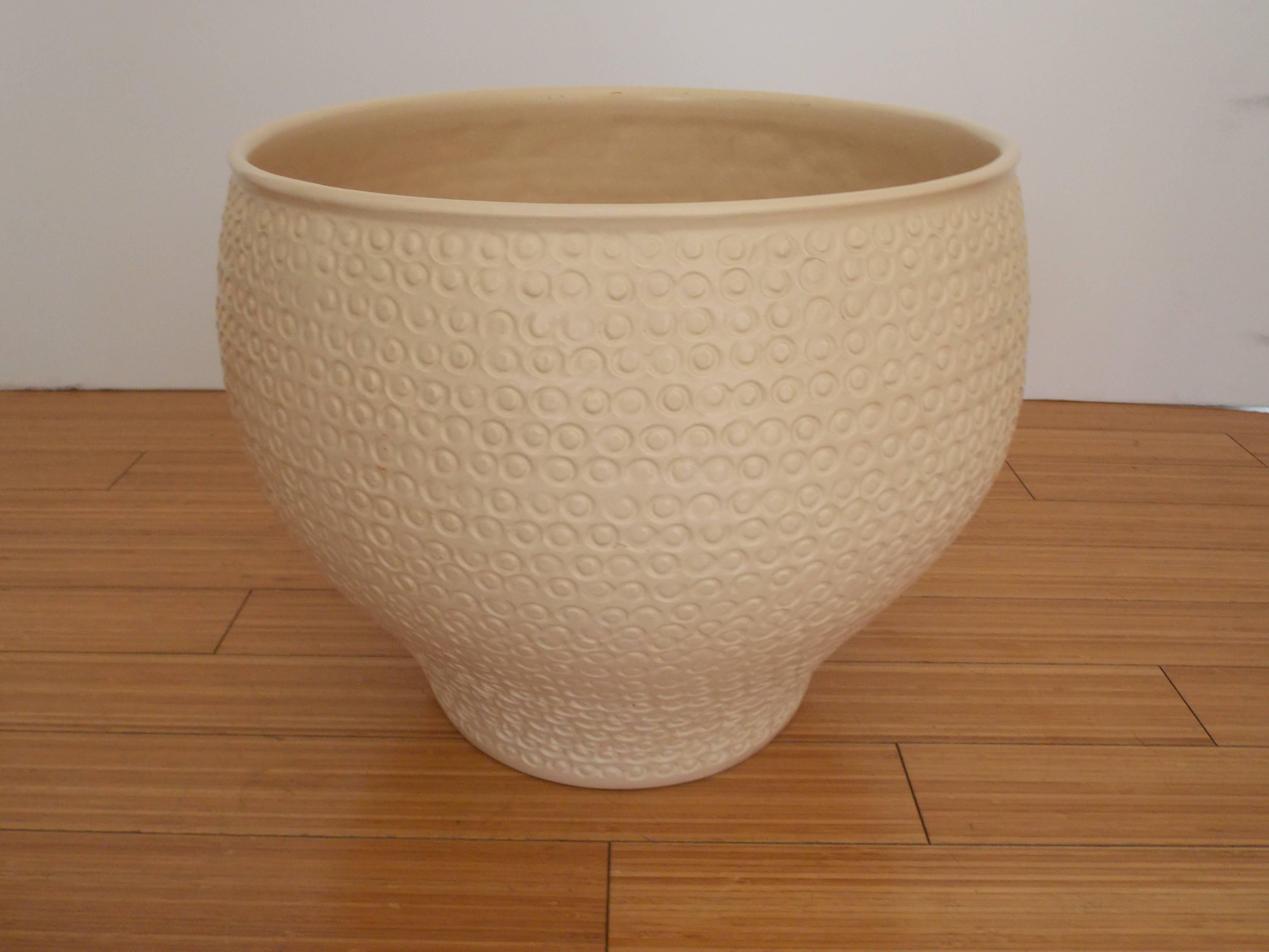 A nice California design.
Made of clay with hand applied Cheerio pattern design with creme colored glaze.
It has a drain hole on the bottom.
No chips, cracks or repairs.
   