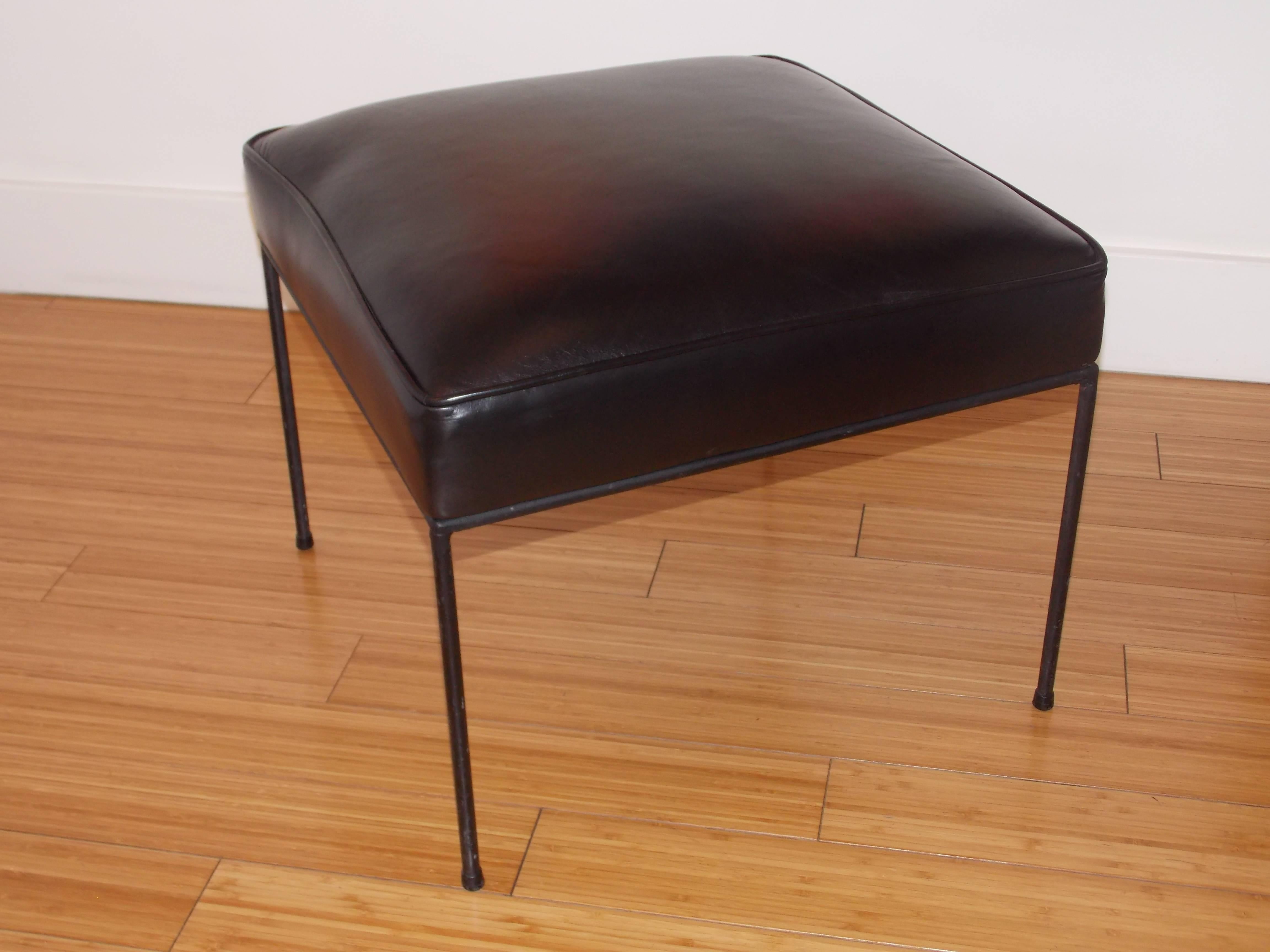 Reupholstered with a chic black leather. The base is rod iron with the original ware, patina and screws. A great humble design to place anywhere in the home or office.
