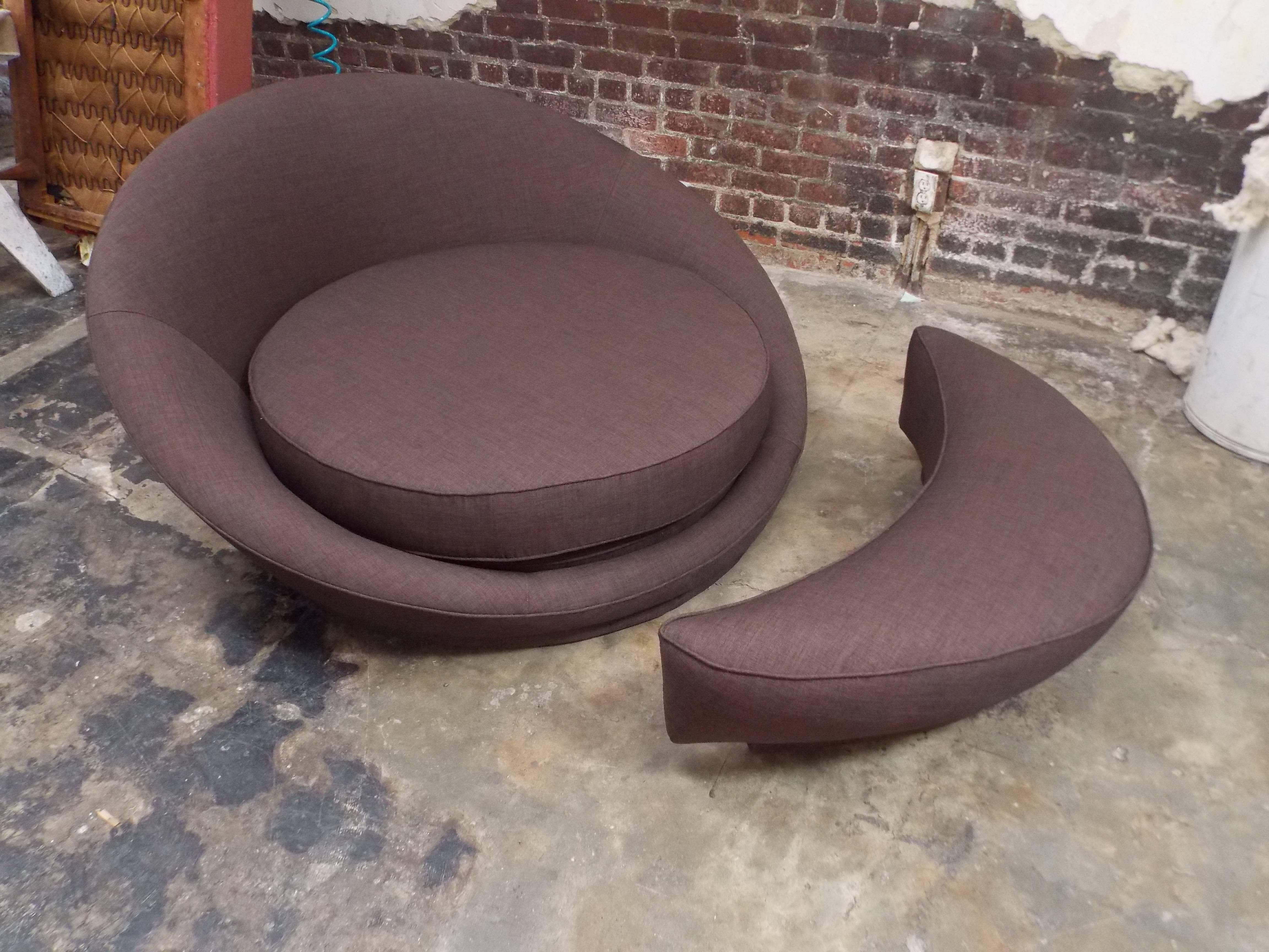 A nice modernist design.
It has been reupholstered with a chic fabric.
It has the original and rare ottoman.
This piece can fit two people comfortably.
The chair without the ottoman is roughly 53