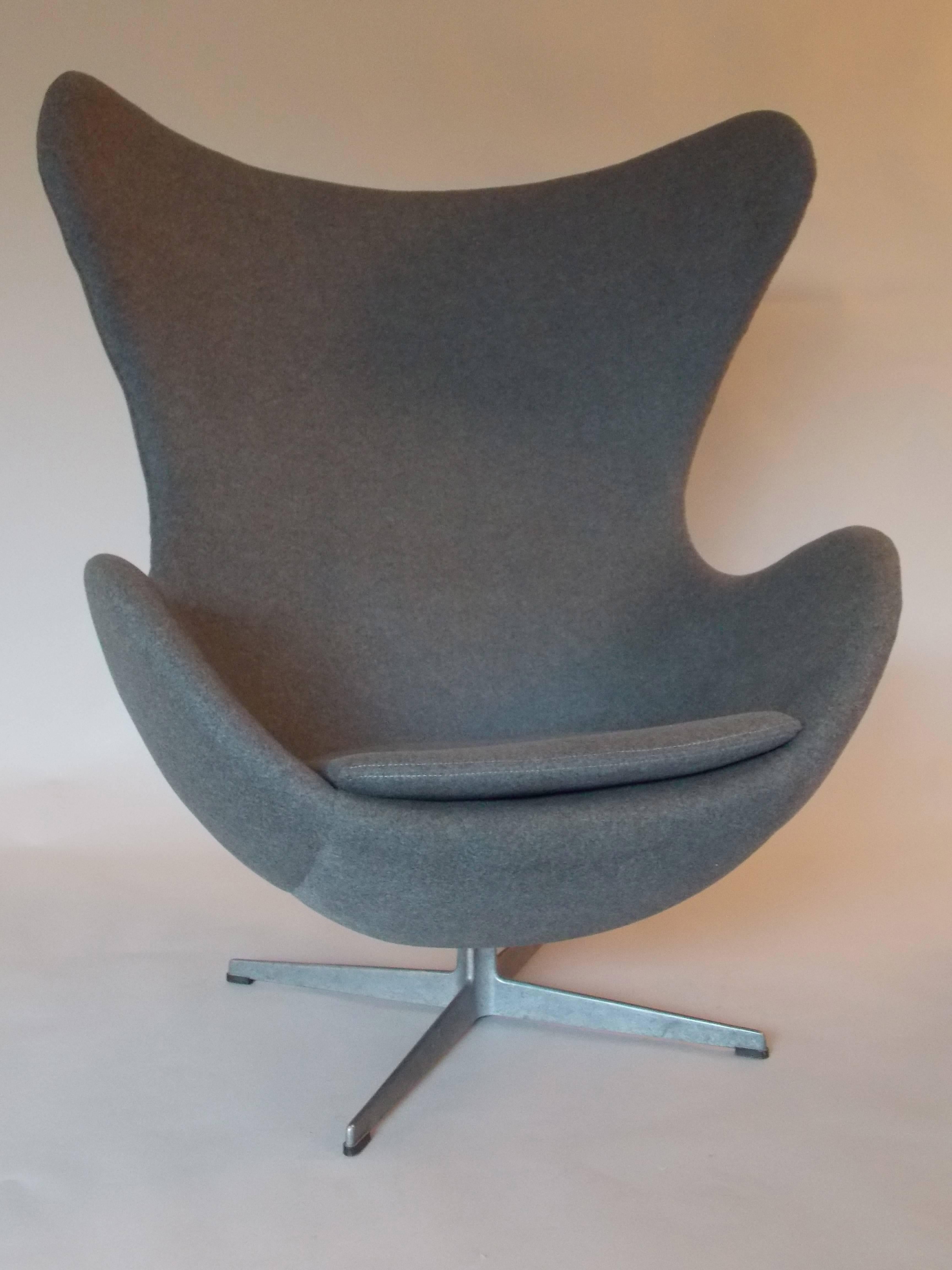 A Classic modernist design.
It has been reupholstered with a nice battle ship grey fabric.
The chair swivels around the base.
The base shows the original ware with patina consistent with age.
The base also has the old label with branded name.
It's