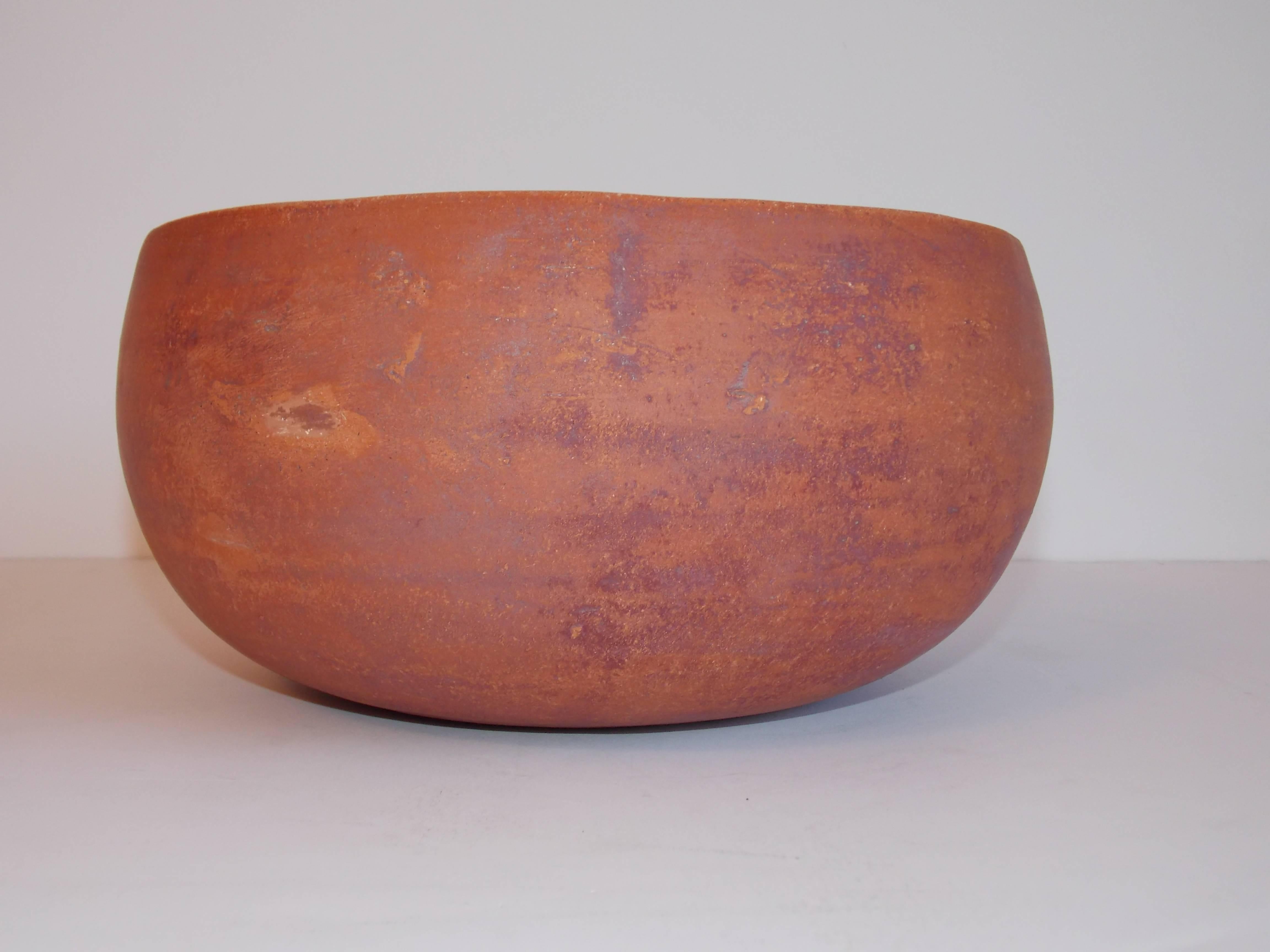 A rare clay design.
The Architectural Pottery Company experimented with terra cotta for only one year during the 1960s. 
It shows minor ware with a beautiful patina.
No chips, cracks or repairs.
It rings like a bell.
It's signed on the bottom