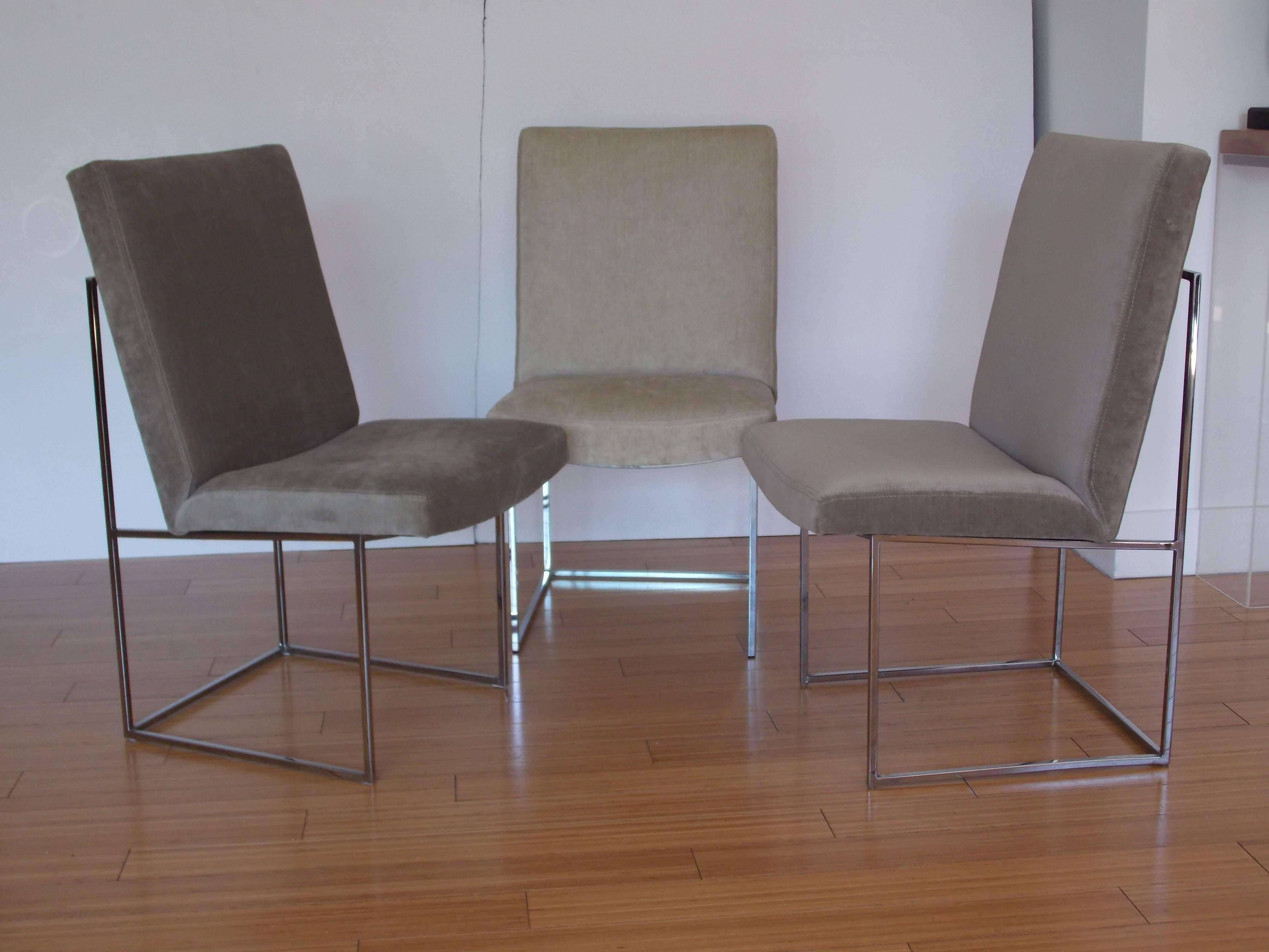 A handsome architectural design.
They've been reupholstered with an elegant mohair fabric.
The original labels have been reattached.
One chair is lighter than the other two, having a two-tone shades of grey effect.
The base is nickle-plated