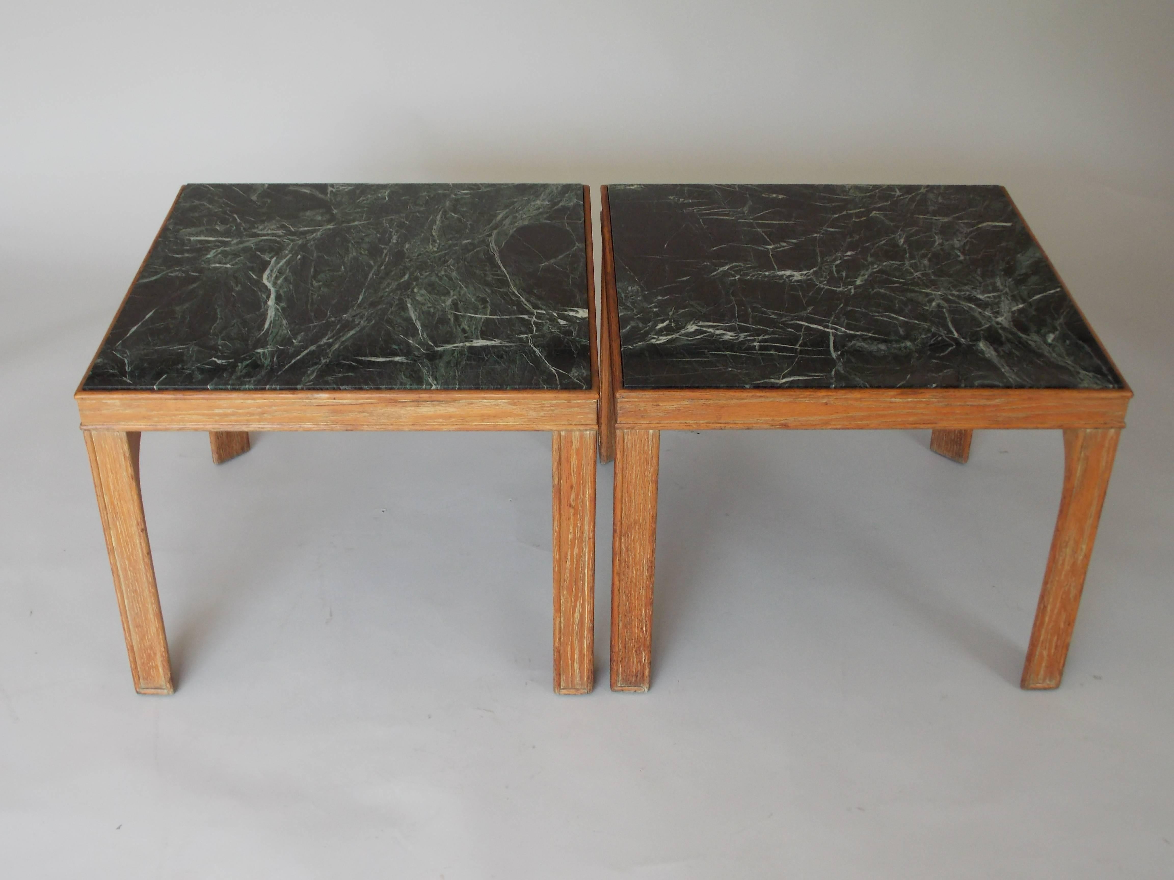 An elegant pair of occasional tables.
Great to use as end tables or coffee tables.
Made of solid oakwood with original black marble tops with nice veins and a subtle green hue.
The wood has remnants of it being cerused once, but has since faded.