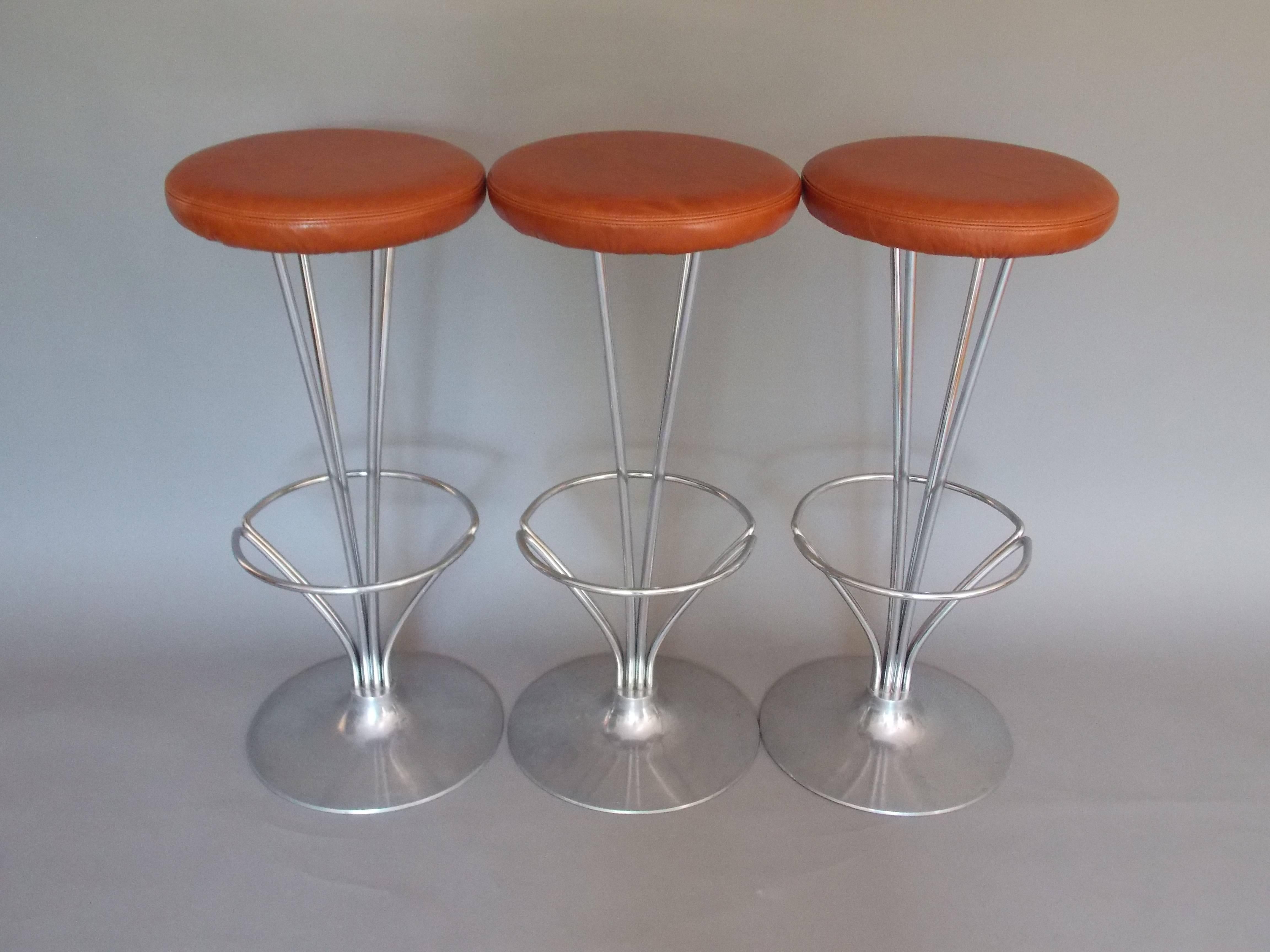A nice set of three architectural Danish designs.
Made of steel with reupholstered distressed cognac hue leather.
The steel shows minor wear / patina consistent with age.
No damage or repairs.
Solid and sturdy.
    