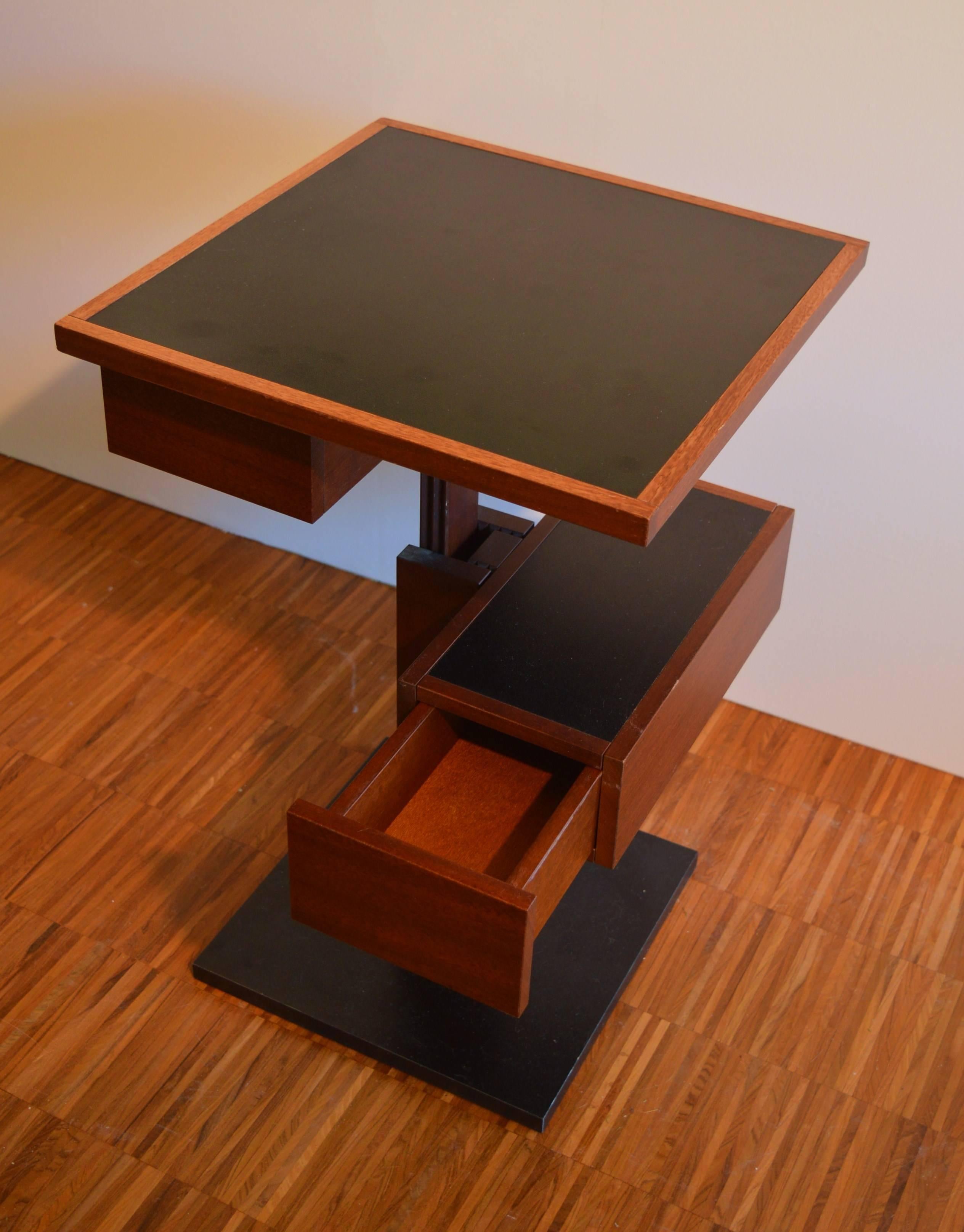 Very rare and exceptional side table with compartment and drawer by Bernard Vuarnesson.
The base and the top are executed in laminated black, while the rest of the frame is in solid Iroko-wood.
This table is adjustable in height and in a very good