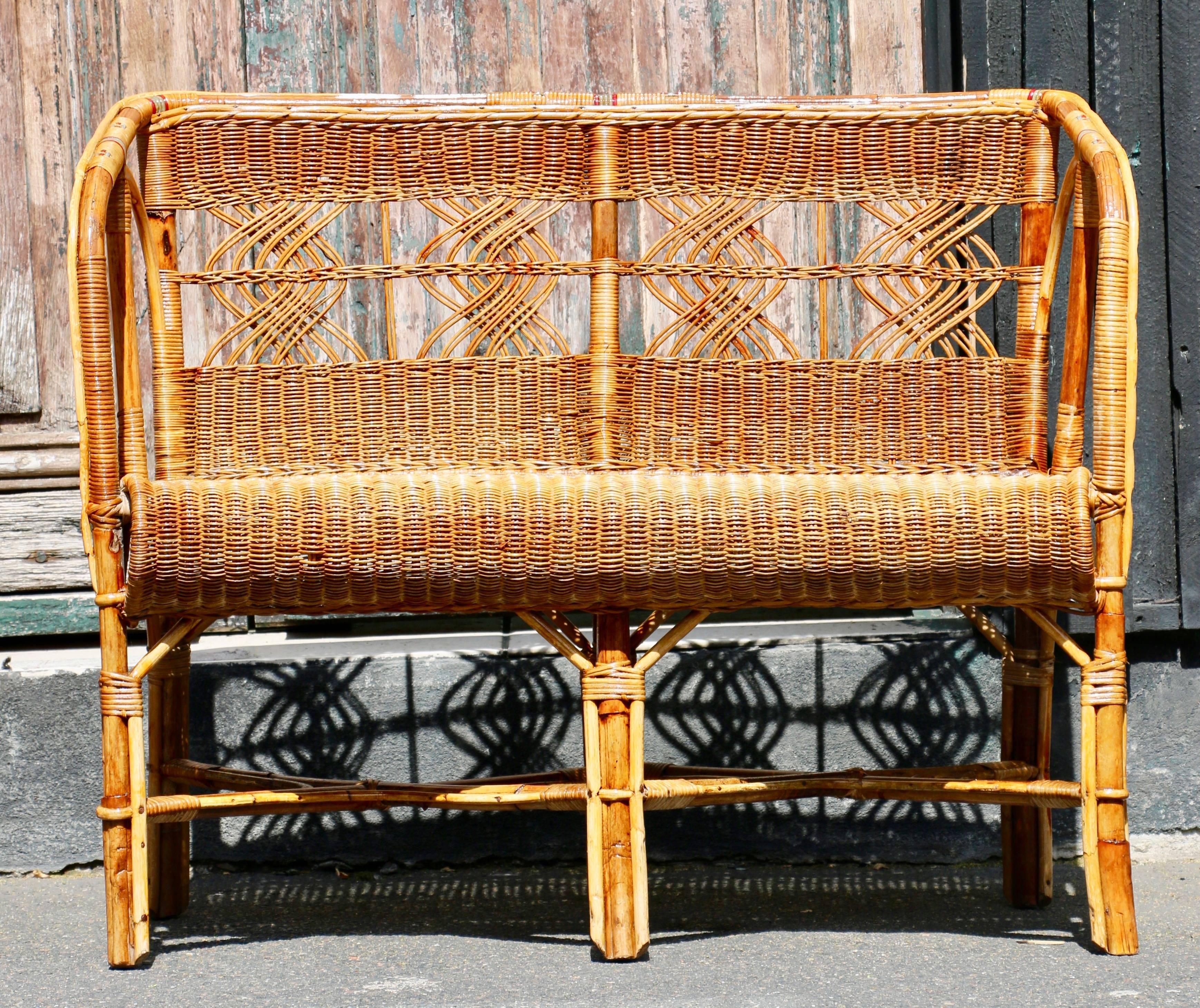 Nice 1960s Italian living room or garden furniture , a small two seat bench in rattan. The two chairs are sold . Very good condition.