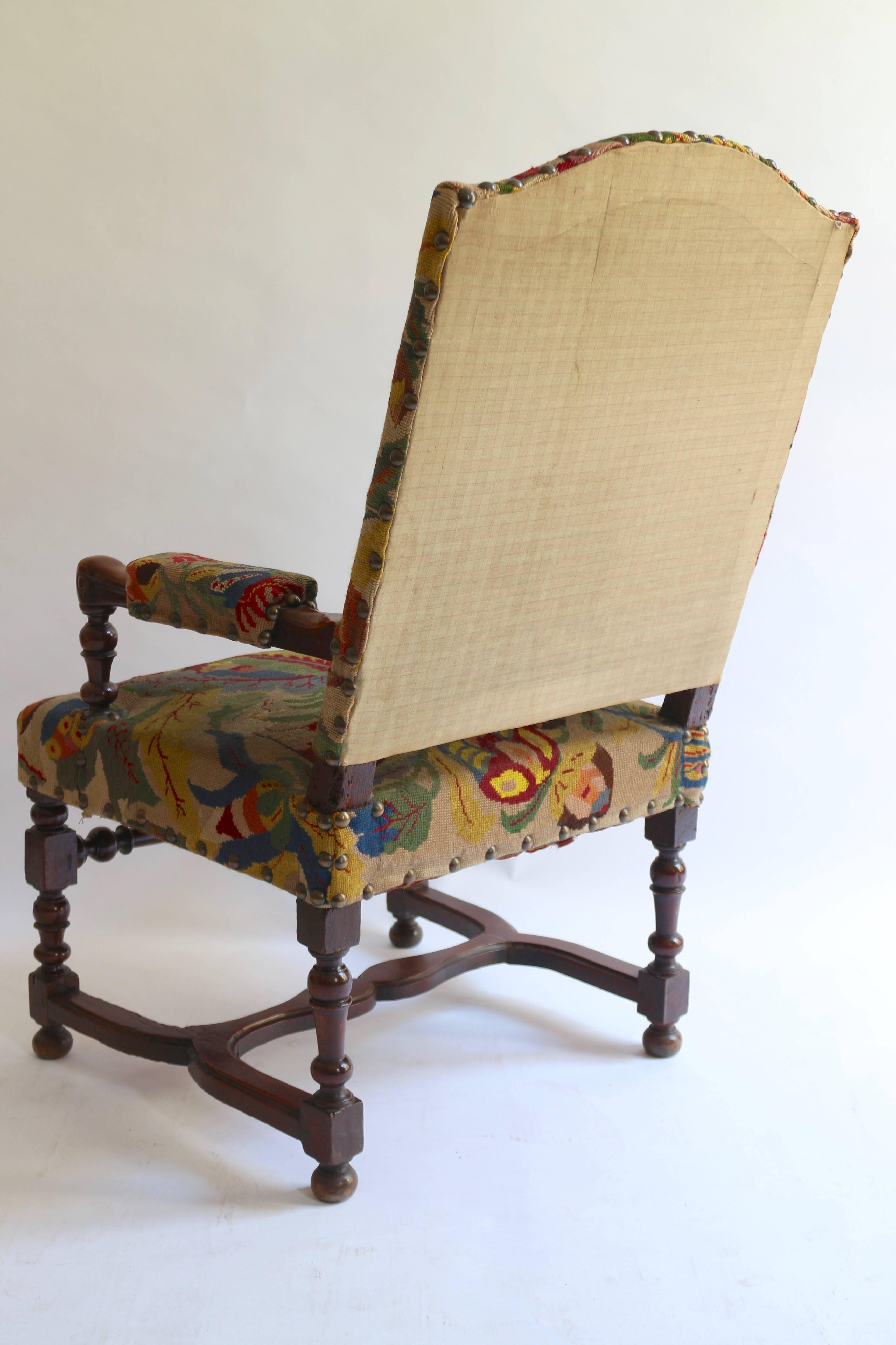 Very elegant armchair in walnut and upholstered with old colorful tapestry.
Very comfortable and stable seating.
Some old restorations but well done.