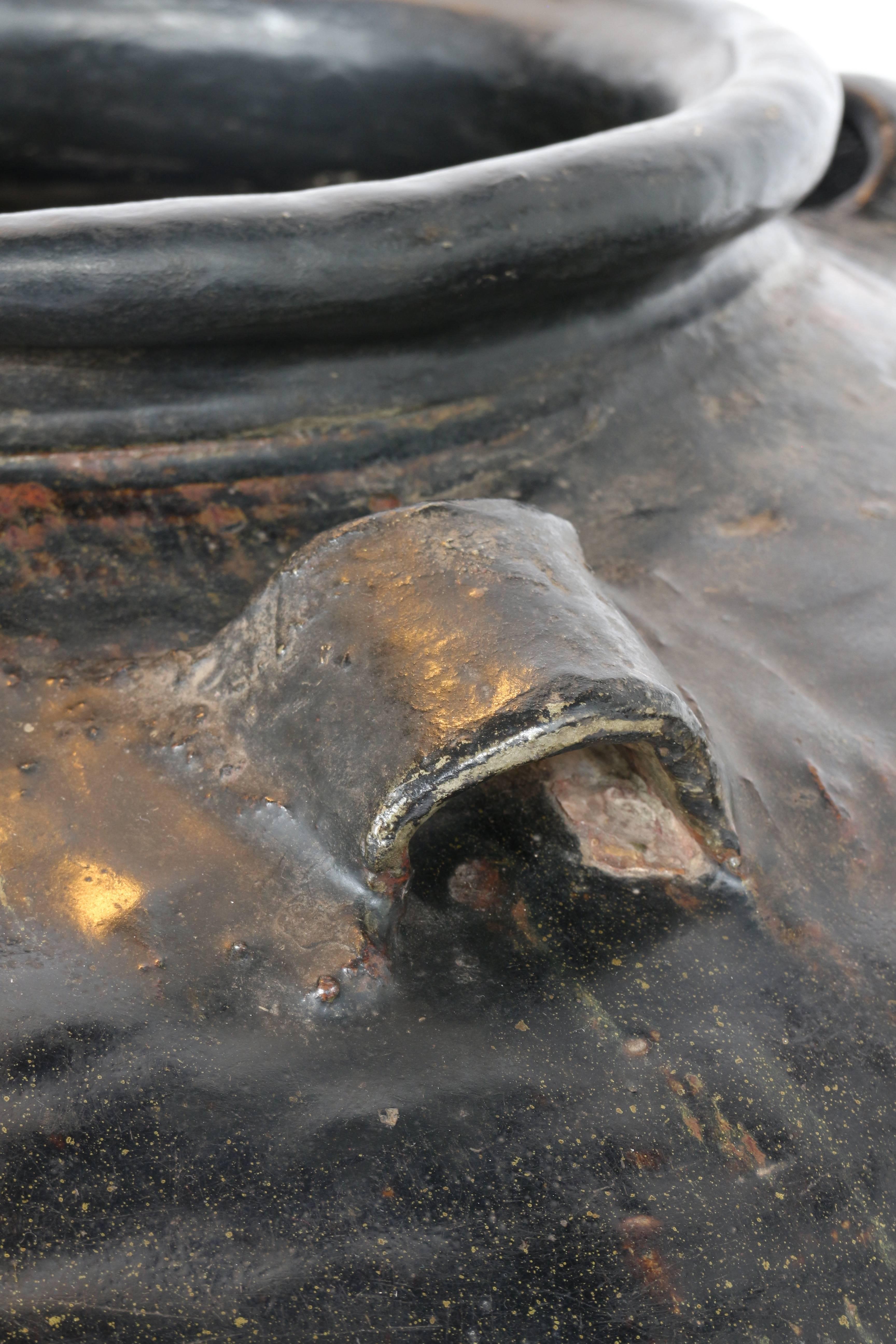A beautiful big jar in dark brown glazed terracotta.
  