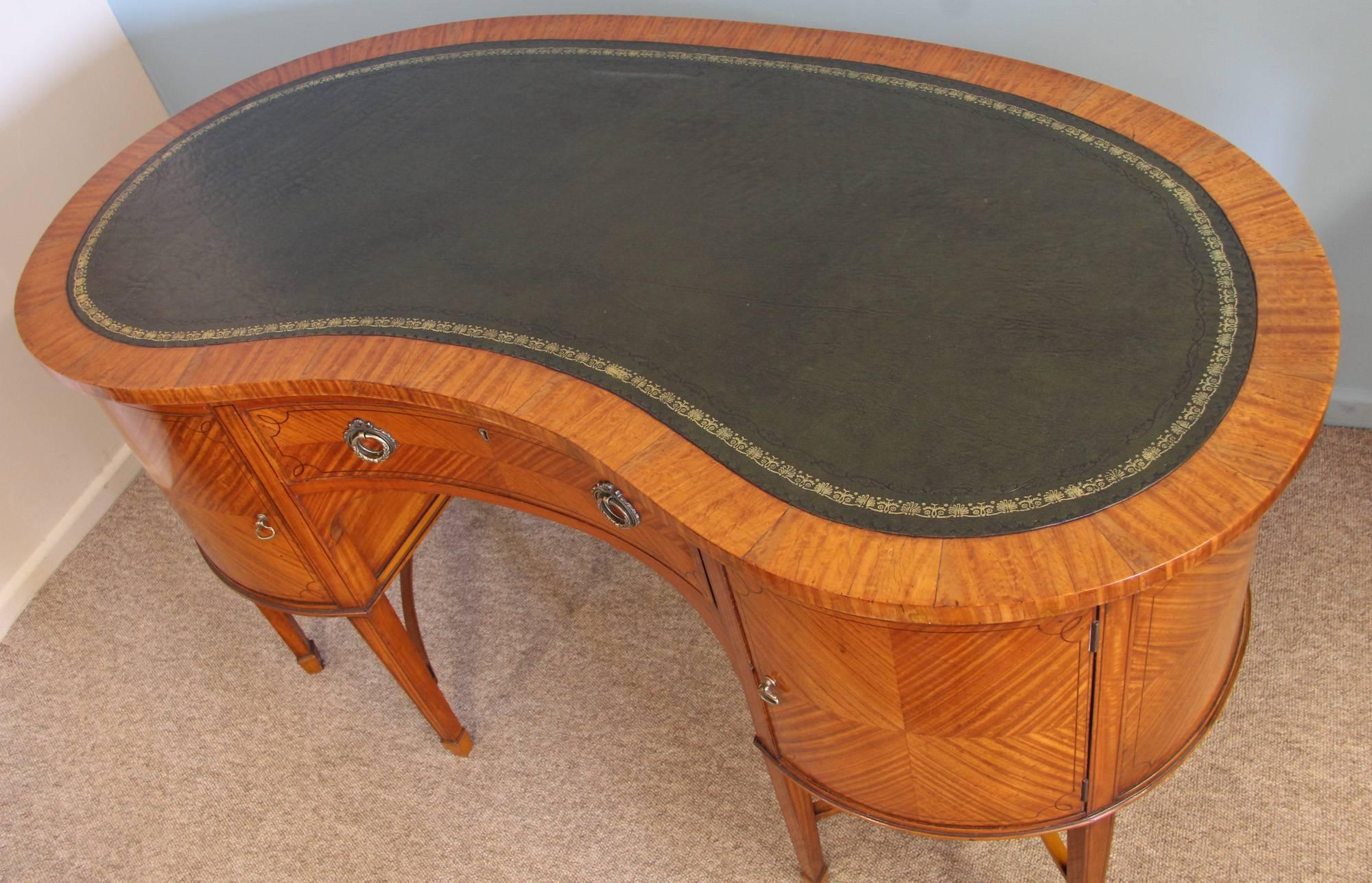 Satinwood kidney shaped desk with quarter veneered door panels on square tapering feet, circa 1890.

All of the items that we advertise for sale have been as accurately described as possible and are in excellent condition, unless otherwise stated.