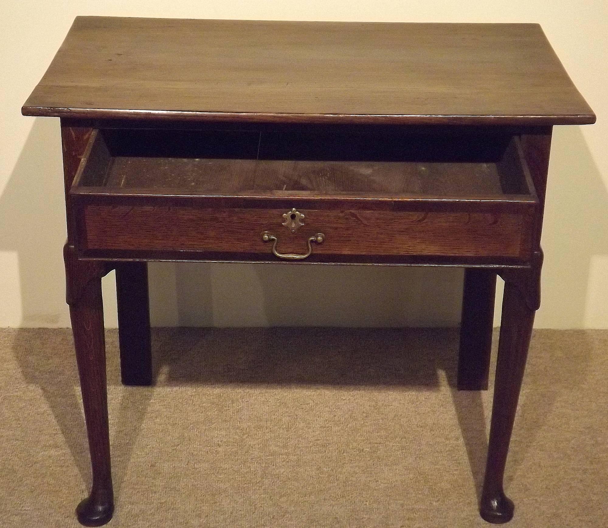 A mid-18th century oak lowboy on pad feet. An attractive Mid-Century country oak lowboy with single frieze drawer capped carved legs and pad feet. Good color and original brass, circa 1750.

All of the items that we advertise for sale have been as