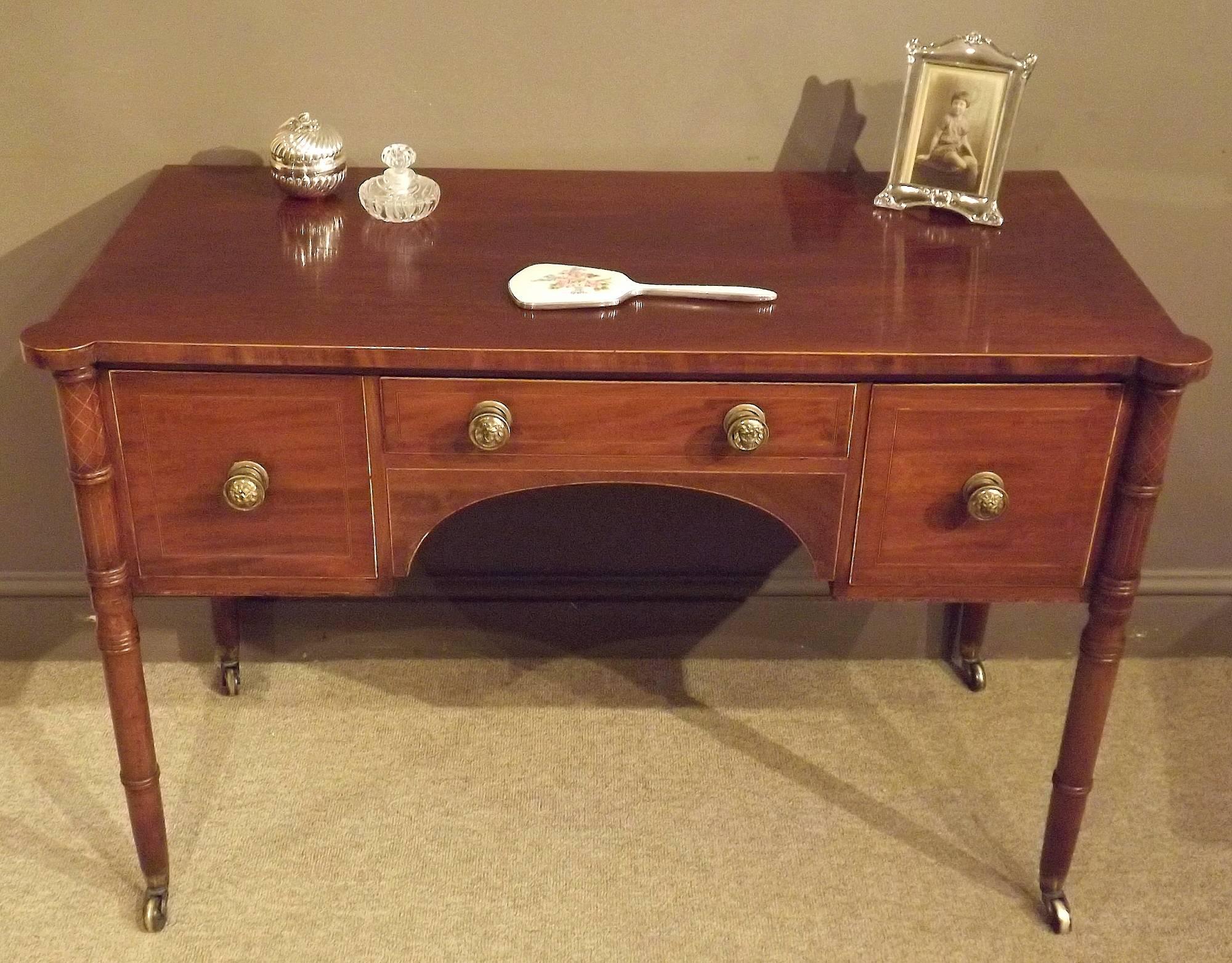 An attractive Regency period dressing table with boxwood stringing and original brass lions mask handles, circa 1820.

Dimensions:
Height 29.5