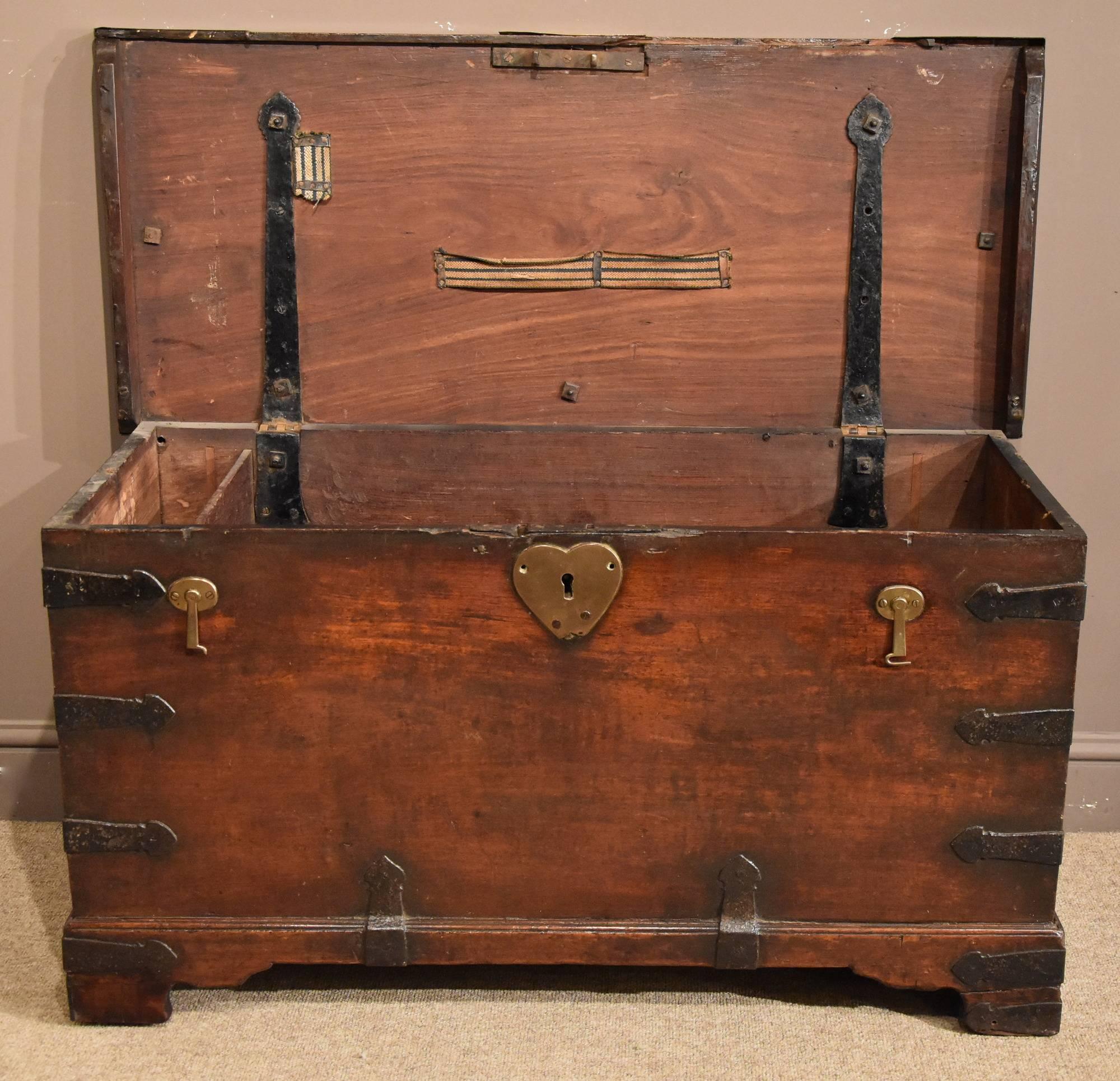 A handsome Anglo Indian teak and Iran bound trunk with brass fittings/plaques. Good color and patina, mid-19th century.

All of the items that we advertise for sale have been as accurately described as possible and are in excellent condition,