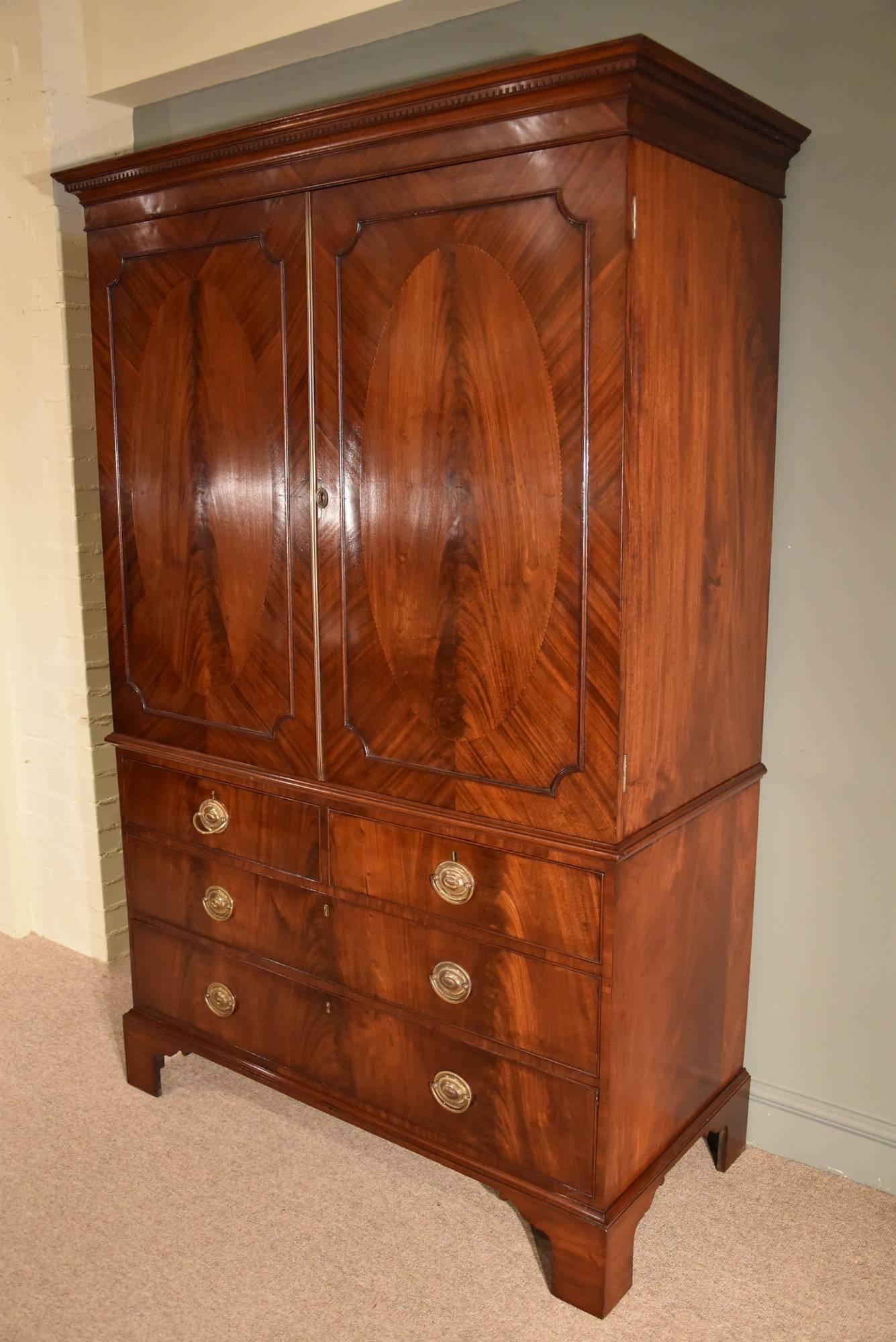 Early 19th Century George III Mahogany Linen Press with Oval Flamed Panels