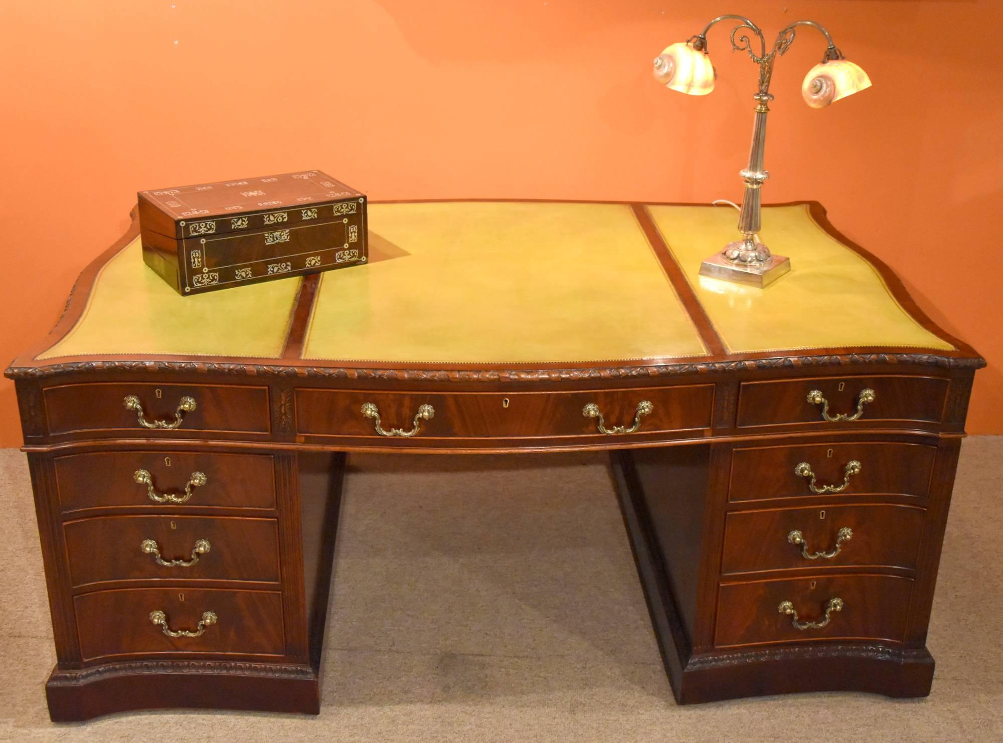 George III style mahogany serpentine partners desk a rare and impressive large mahogany serpentine shaped pedestal partners desk in the manner of Thomas Chippendale. The recently triple panel light green leather inset top sits above an arrangement