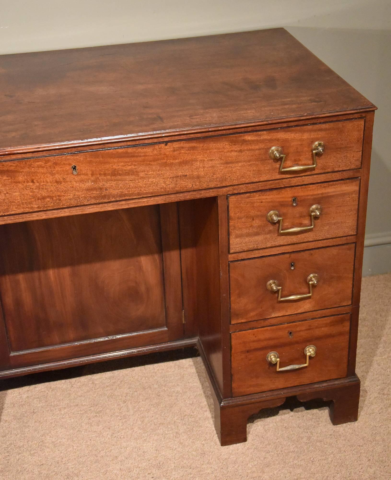 A good Regency period mahogany kneehole desk ebony stringing and original handles.

Dimensions
Height 32