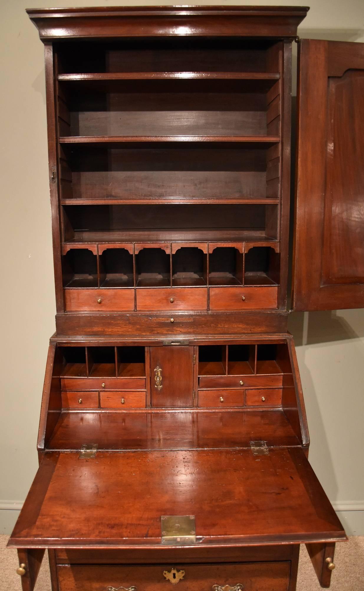 A fine small George II mahogany bureau bookcase with fitted upper and lower section. Also original handles escutcheons locks and feet.

Dimensions
Height 70