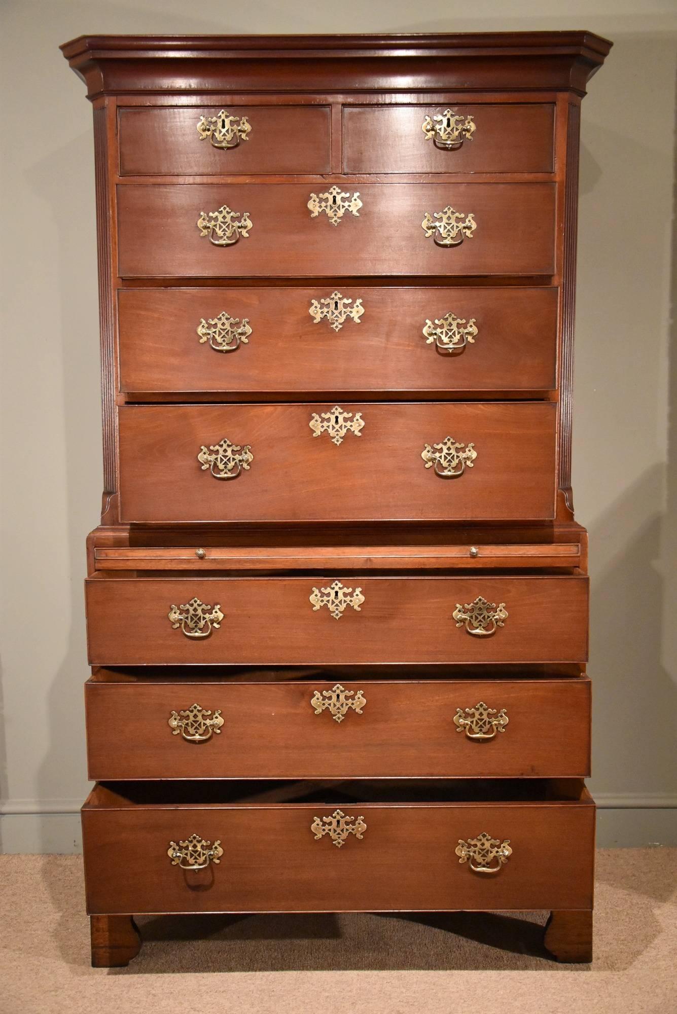 George III mahogany chest on chest with original handles and escutcheons, brushing slide, canted, reeded corners to top all on original bracket feet.

Dimensions
Height 75.5