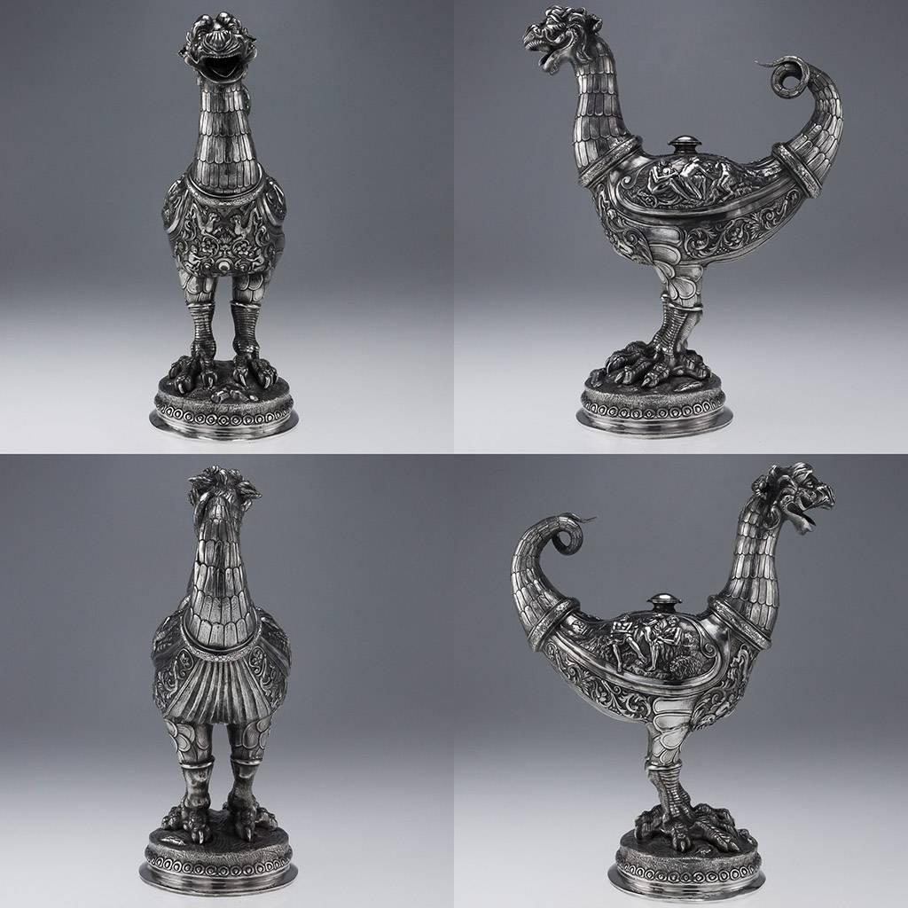 Antique 19th century rare and magnificent pair of German solid silver caquesseitao aquamaniles / monumental ewers, both heavily cast in the style of Renaissance mythological birds with dragon heads and scaly tails, the bodies are embossed with