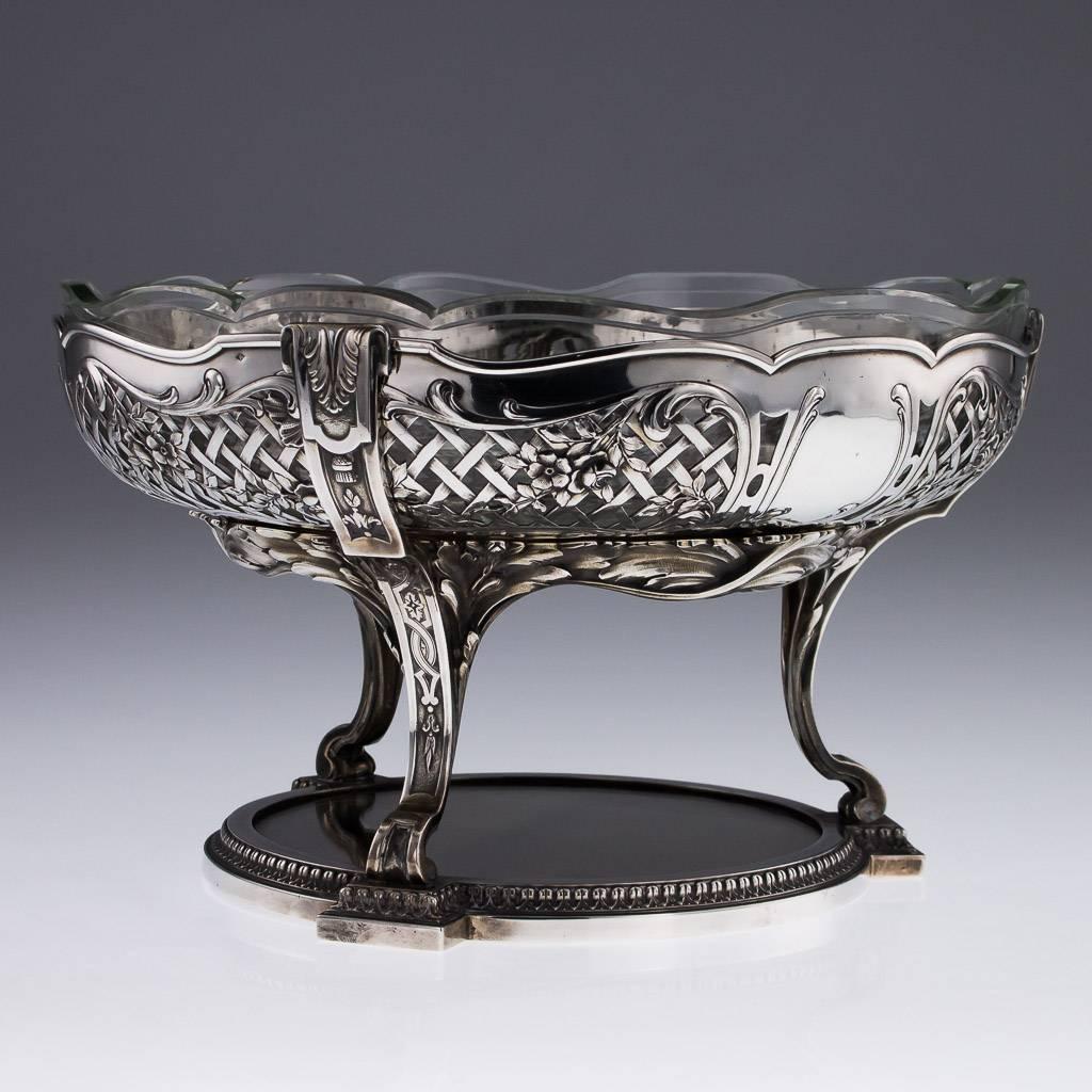 Description.

Antique 20th century large and impressive French solid silver centerpiece bowl and stand, of shaped-circular form, the silver stand fitted with a mirrored plateau, the removable bowl pierced and chased with flowers and scroll leaves