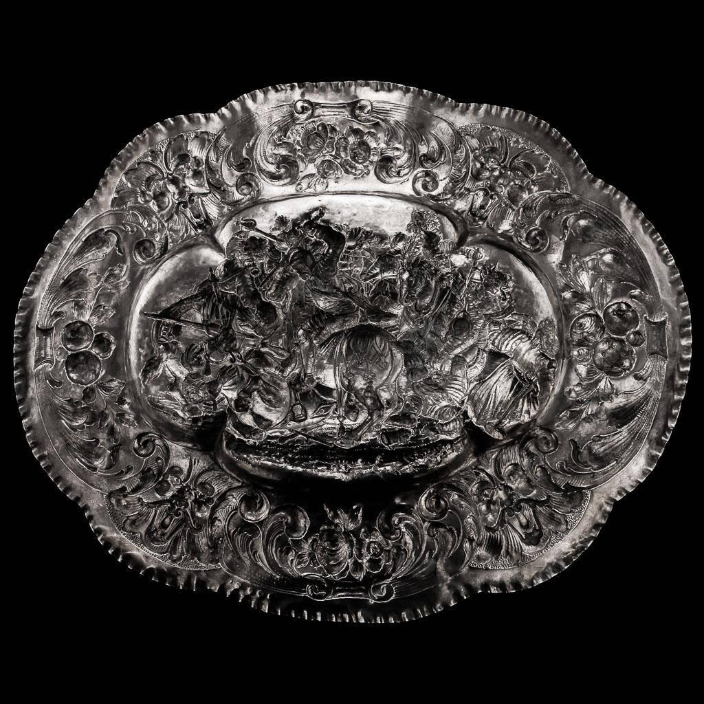
Description:

Antique 19th century German solid silver wall charger / sideboard dish, massive size (69 cm wide), of oval form in the style of the 16th / 17th century silver sideboard dishes / chargers, the border embossed with scrolling foliage,