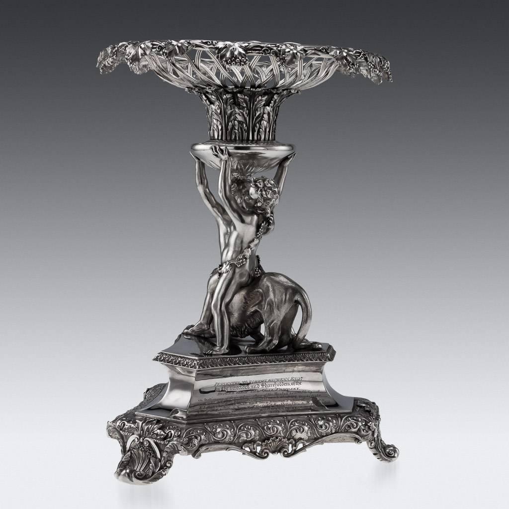 Description

Antique 19th century large and impressive Regency Solid Silver centerpiece/comport, on a triangular base embellished with acanthus leaves and flowers, cast anthemion feet, the sculptural cast stem modelled as two young cherubs sitting
