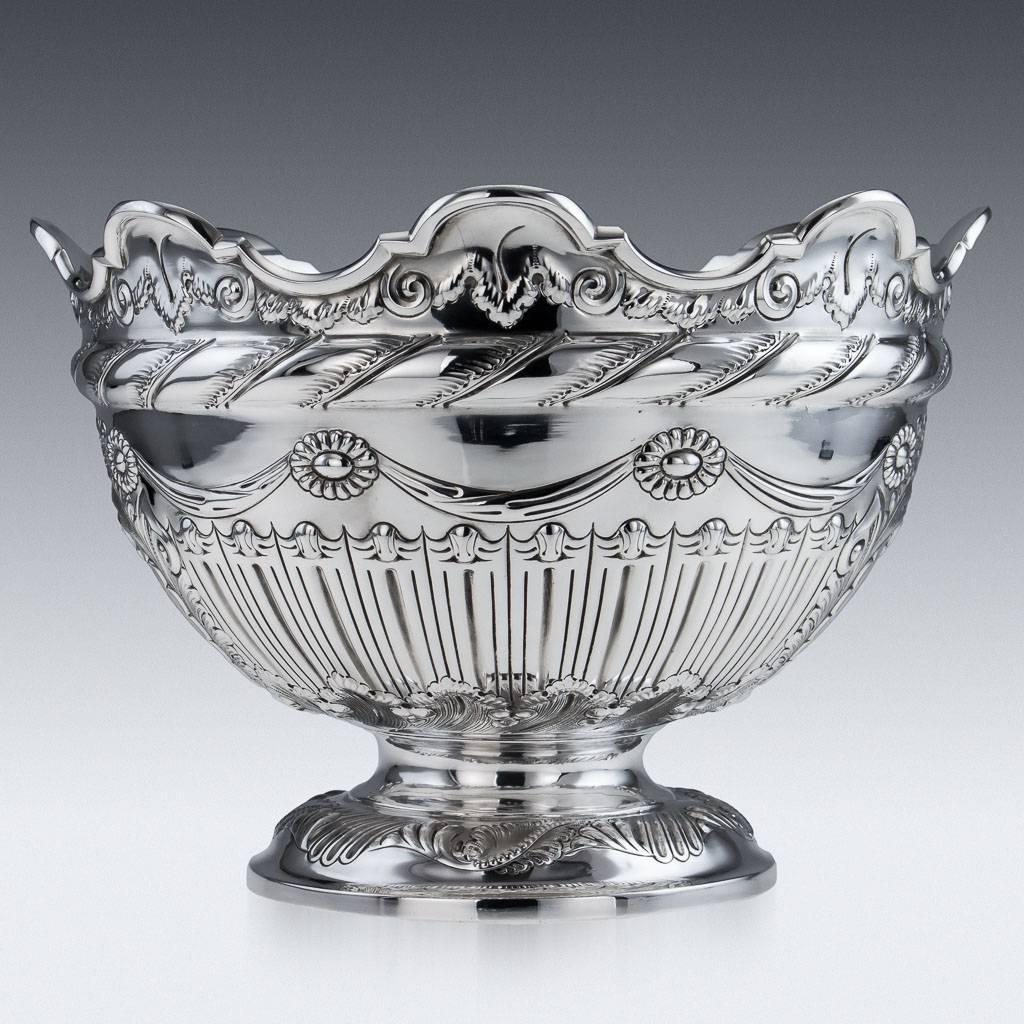 Antique 19th century Victorian solid silver centrepiece punch bowl, impressive size and highly decorative design, of circular form profusely chased with scrolling foliage, vacant cartouche to one side. Hallmarked English Silver (925 Standard),