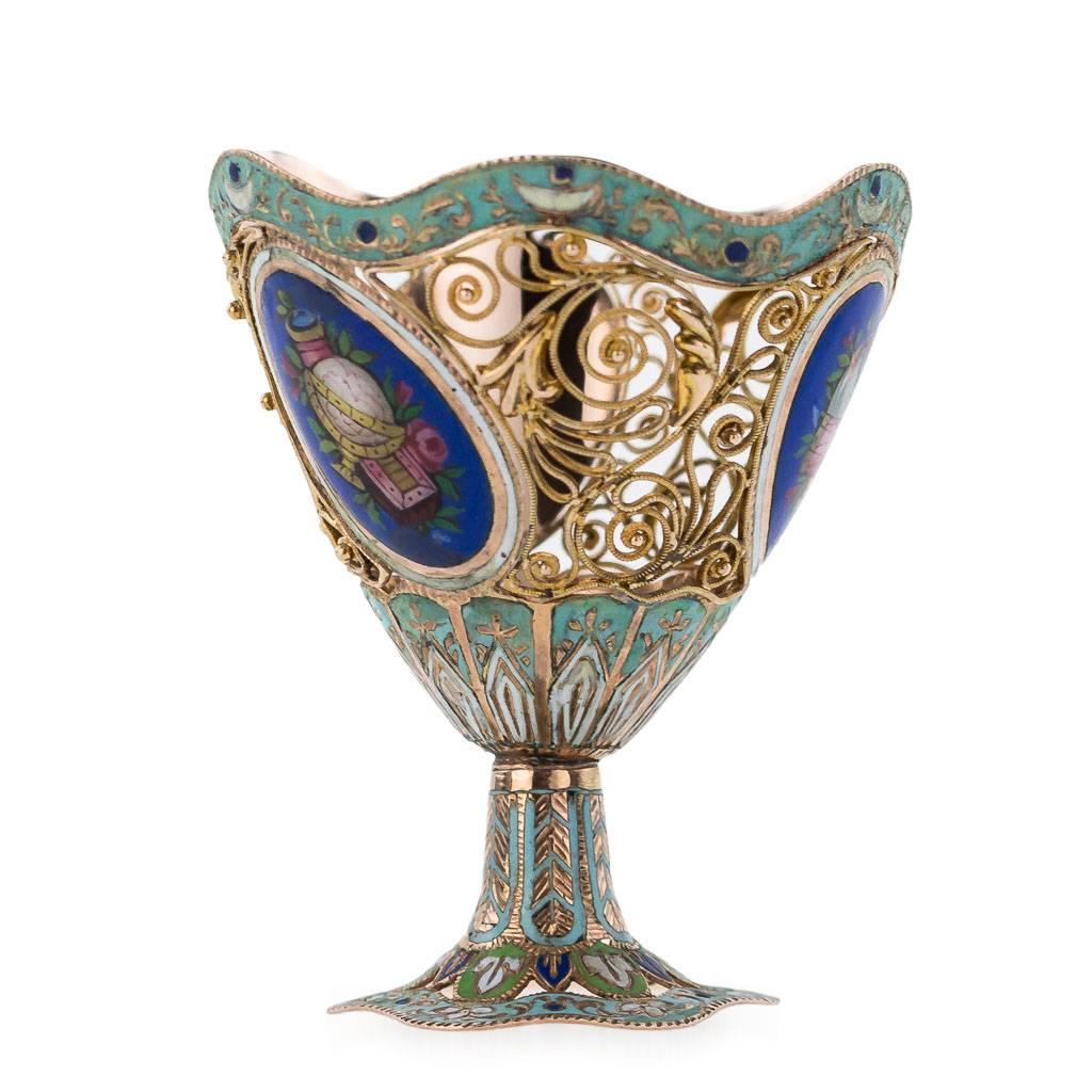 Antique early 19th century Swiss 18-karat 750 gold and enamel zarf made for the Turkish market. Vase shaped of intrecate gold filigree applied with leaves and scroles with oval cartouches of enameled flowers and musical instruments on dark blue